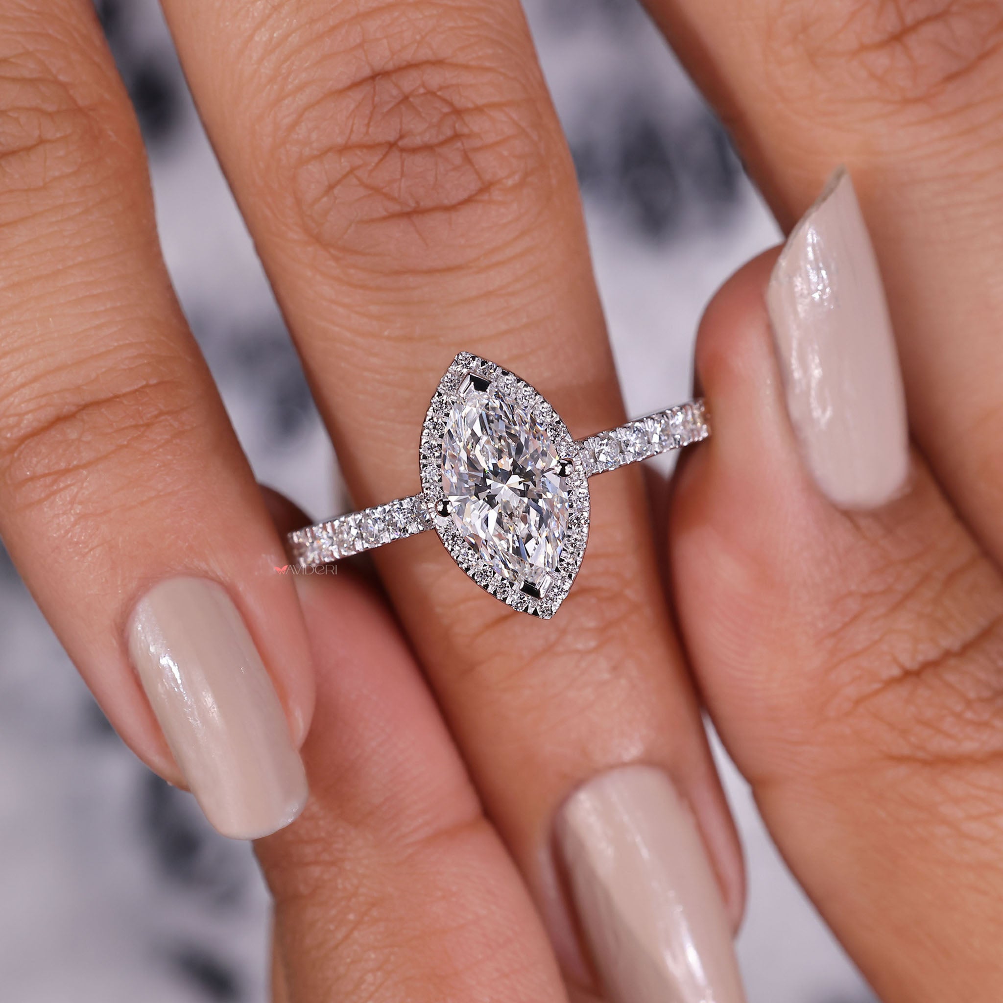 Exquisite marquise halo adorned with pavé diamonds, enhancing the sparkle and brilliance of the center stone.