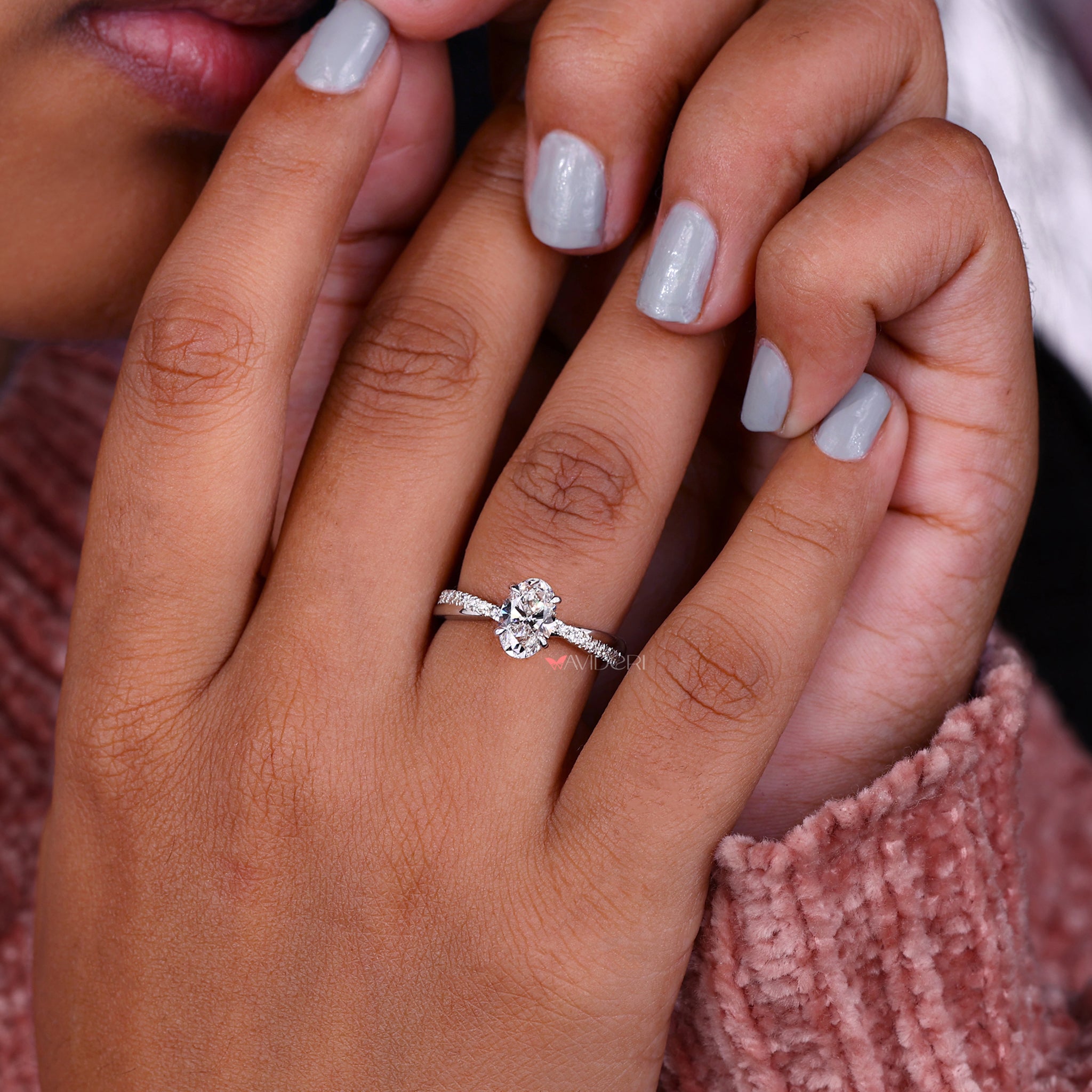 Lab Grown Diamond oval twist engagement ring with pave setting for a modern and eco-friendly jewelry option.