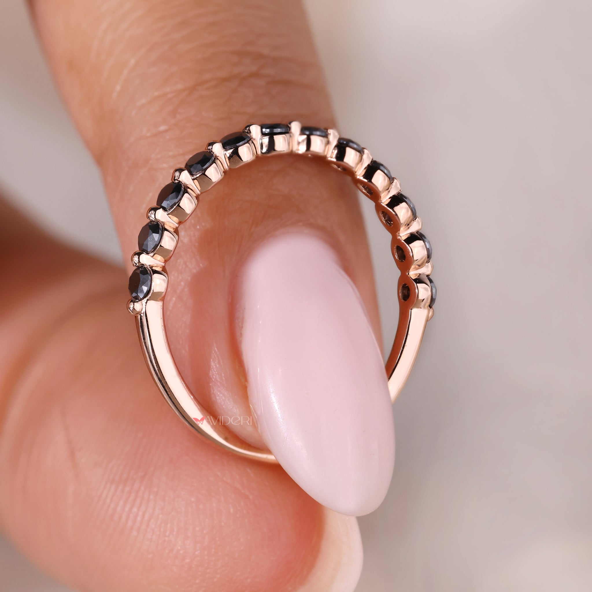 Rose gold wedding band featuring moissanite stones for a modern touch.