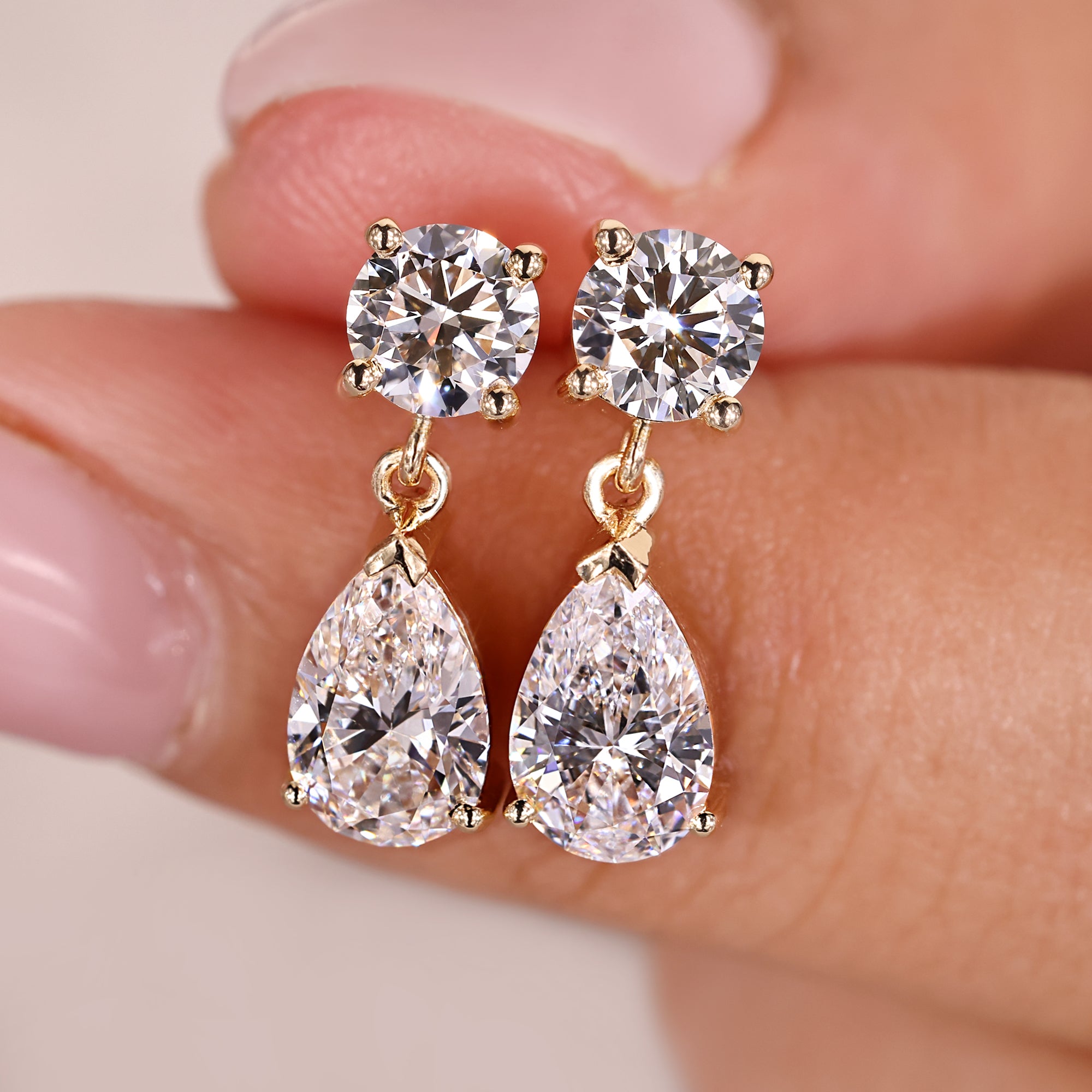 Dangle and drop earrings in round and pear diamond earrings.