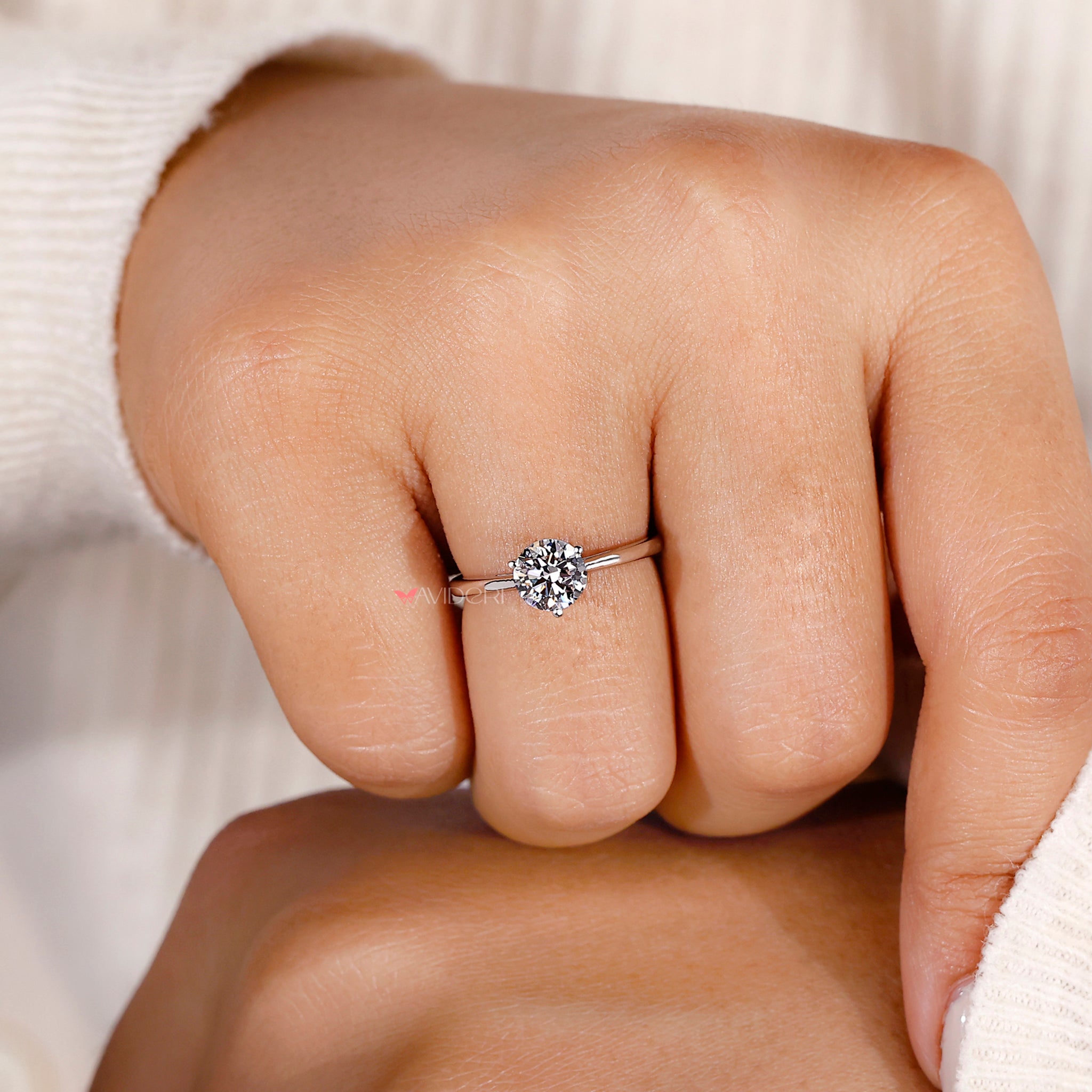 Round cut diamond set in a sleek solitaire design, perfect for those who love simplicity and sophistication.