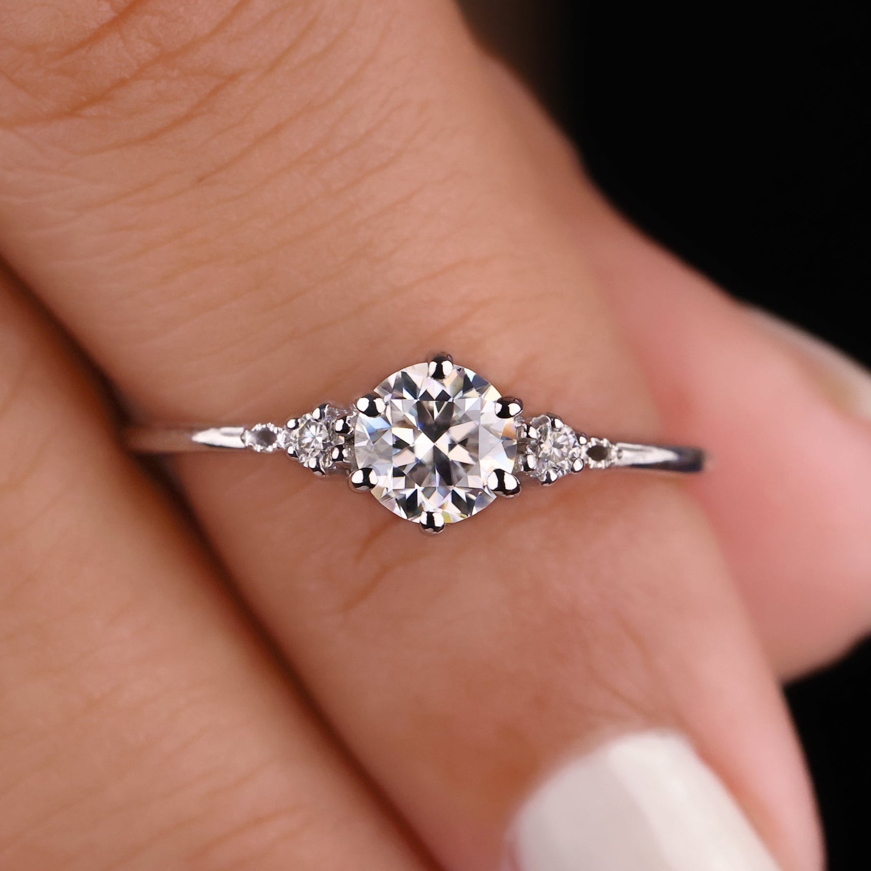 This 3 stone engagement ring features a stunning center stone flanked by two side stones.