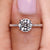Round diamond engagement ring featuring a round diamond pave band and four claw prong setting.
 Round diamond engagement ring featuring a round diamond pave band and four claw prong setting.