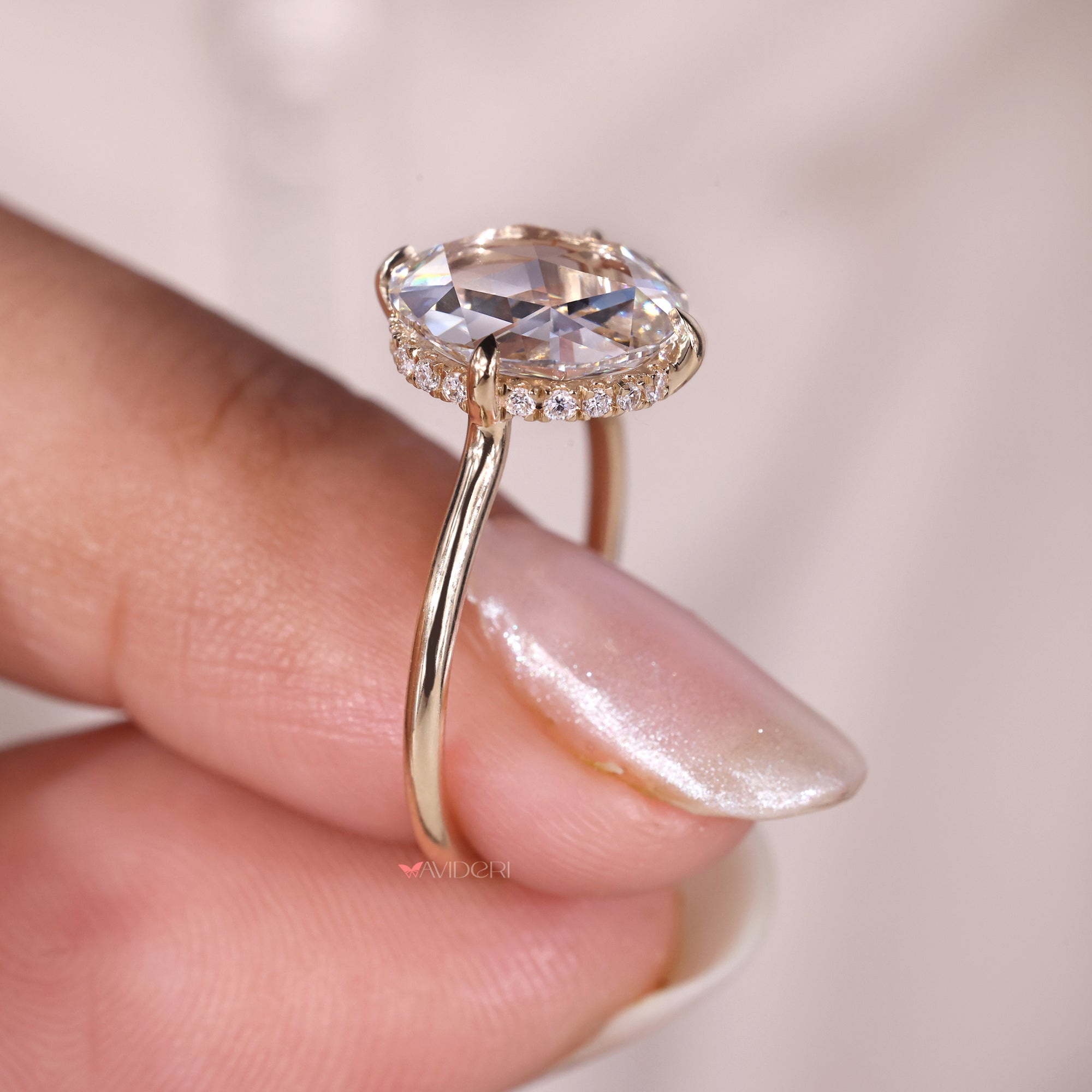 Hidden halo engagement ring with a round diamond, providing subtle brilliance around the stone.