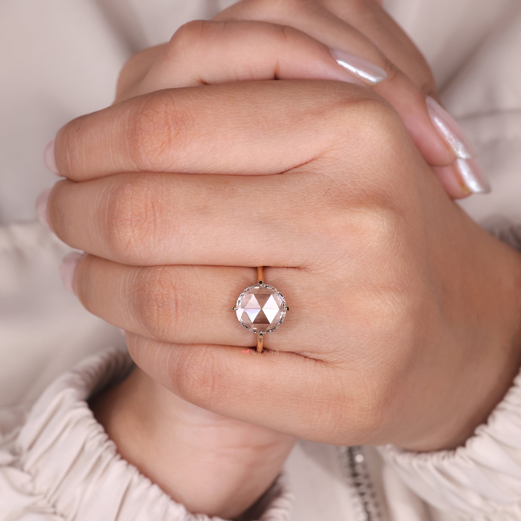 Custom engagement ring featuring a round diamond, tailored to fit her personal style.