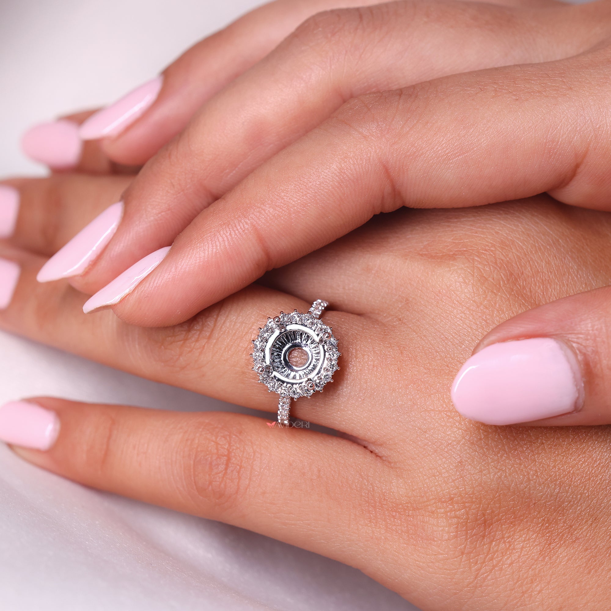 Round cut semi mount diamond ring in white gold.