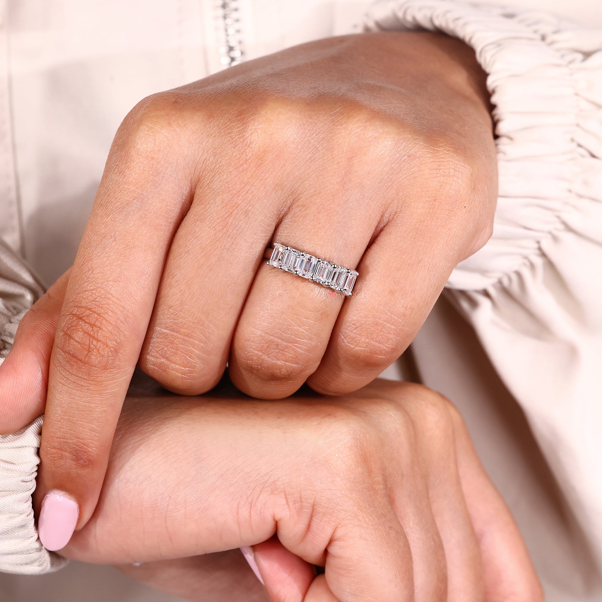 Handmade band with emerald cut six stone layout.