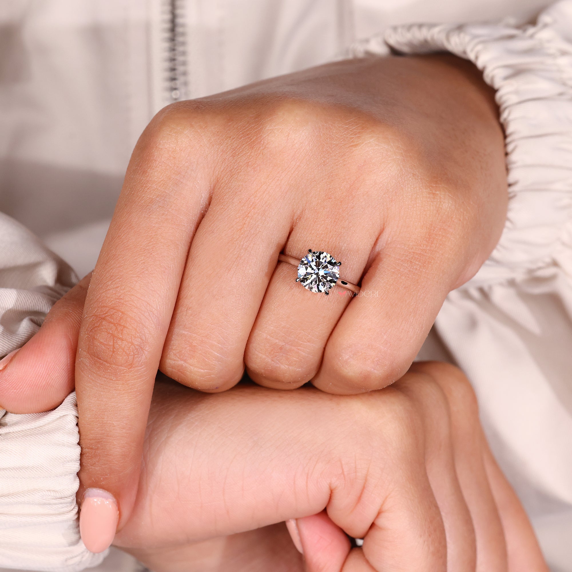 Handmade round diamond ring with hidden halo detail.