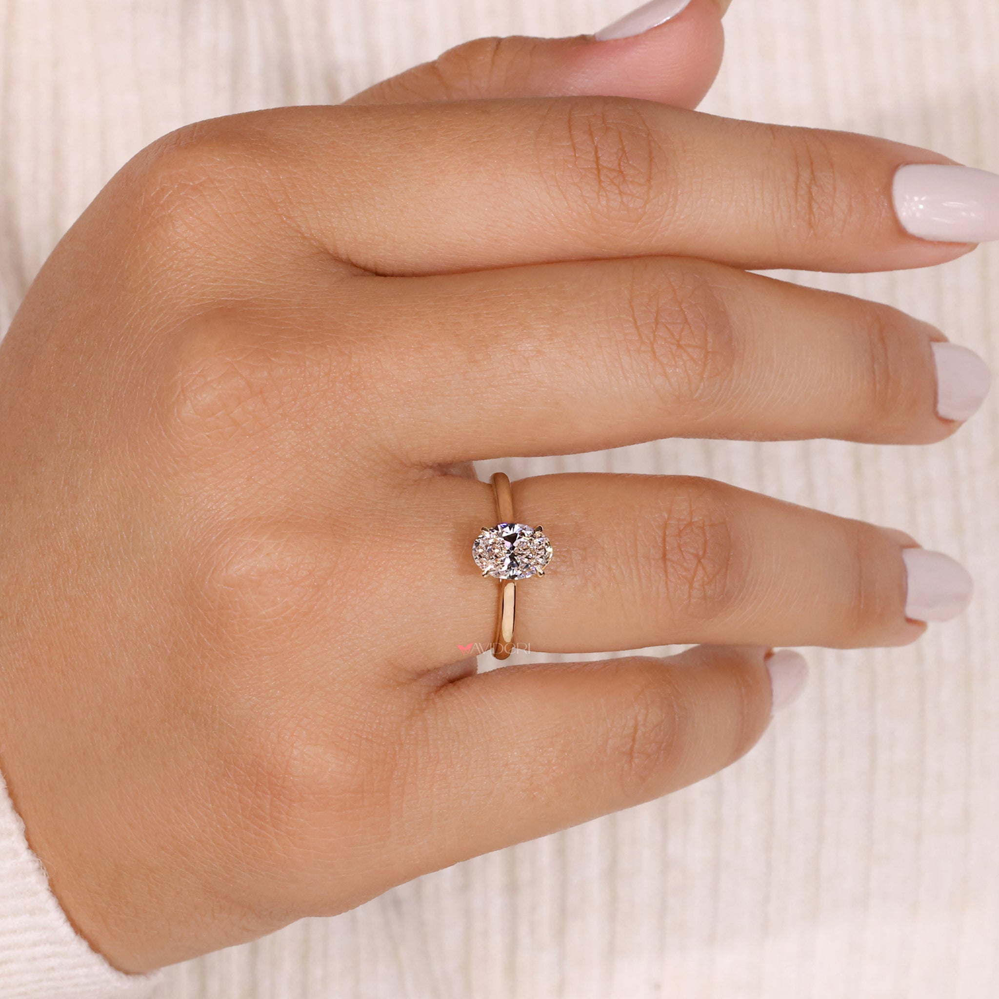 Oval solitaire engagement ring crafted with precision, highlighting the brilliance of a beautiful oval diamond.
