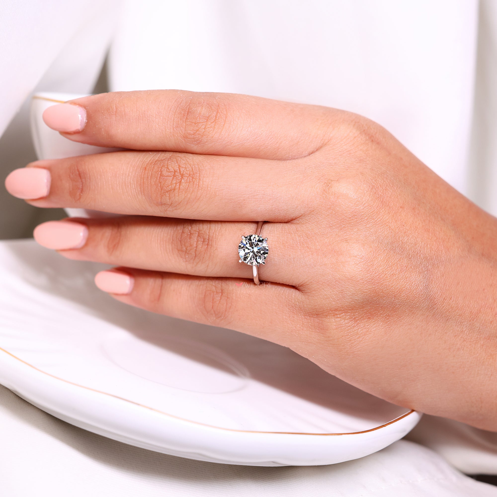 Handmade round diamond ring with hidden halo detail.