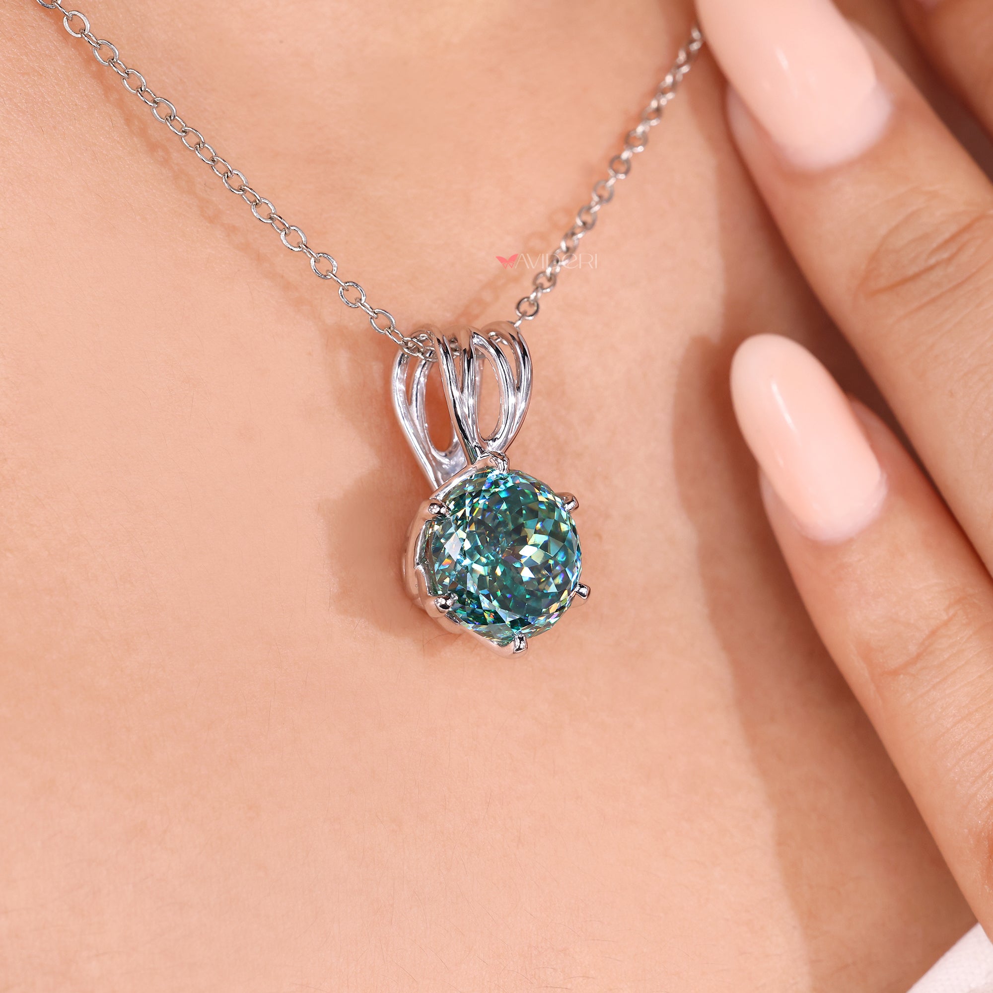 Cyan blue pendant set in a classic round shape.