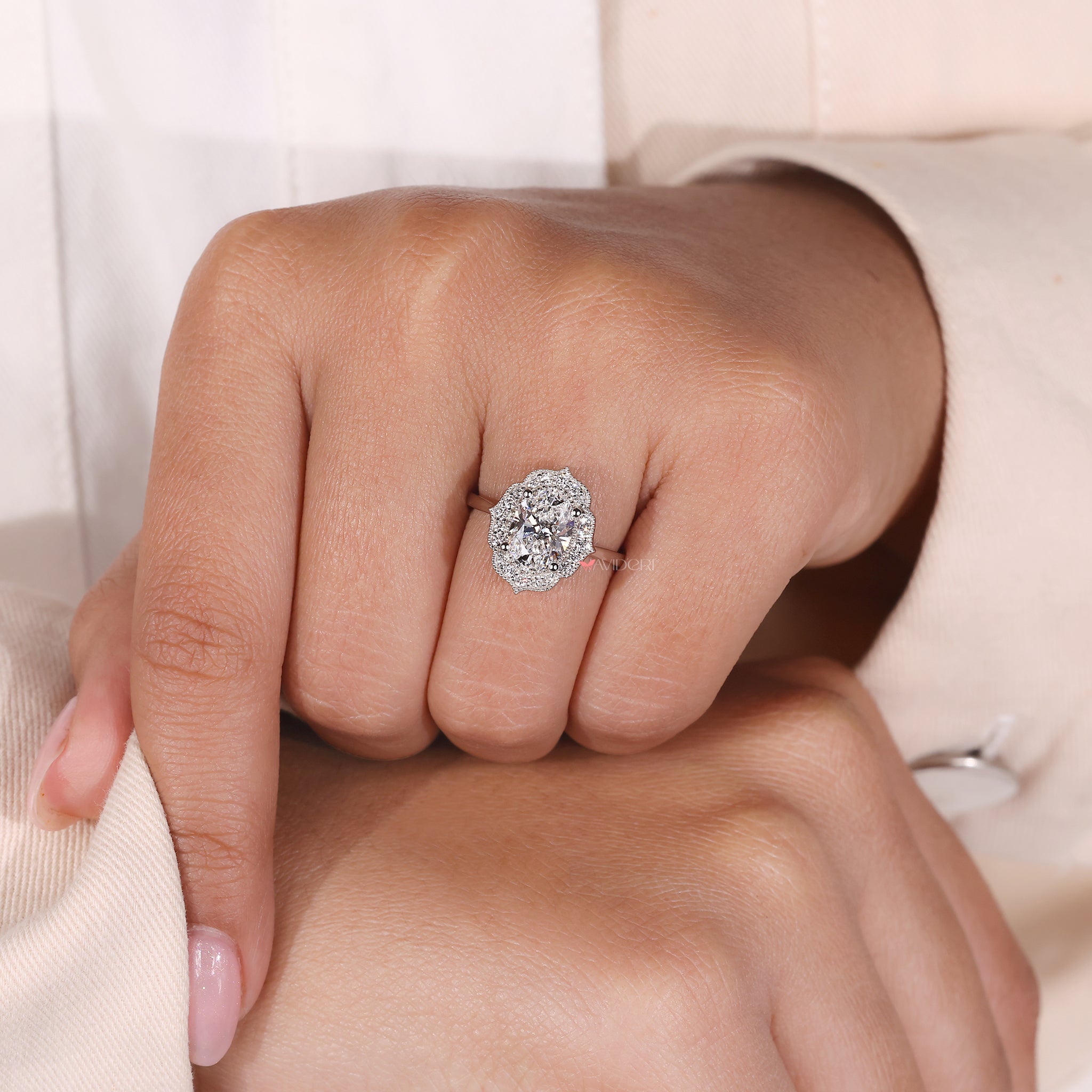 Milgrain setting ring with a delicate design and oval cut center.