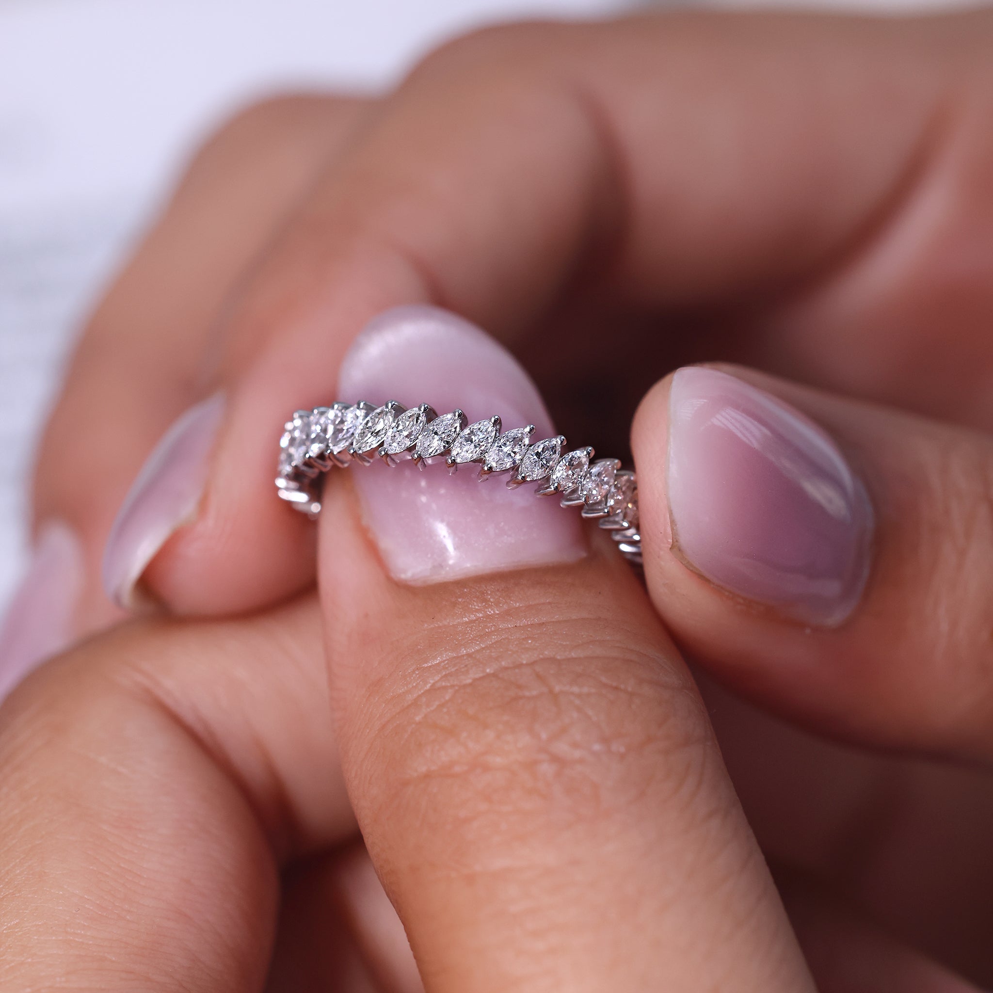 Marquise wedding band shines with a pointed diamond shape.