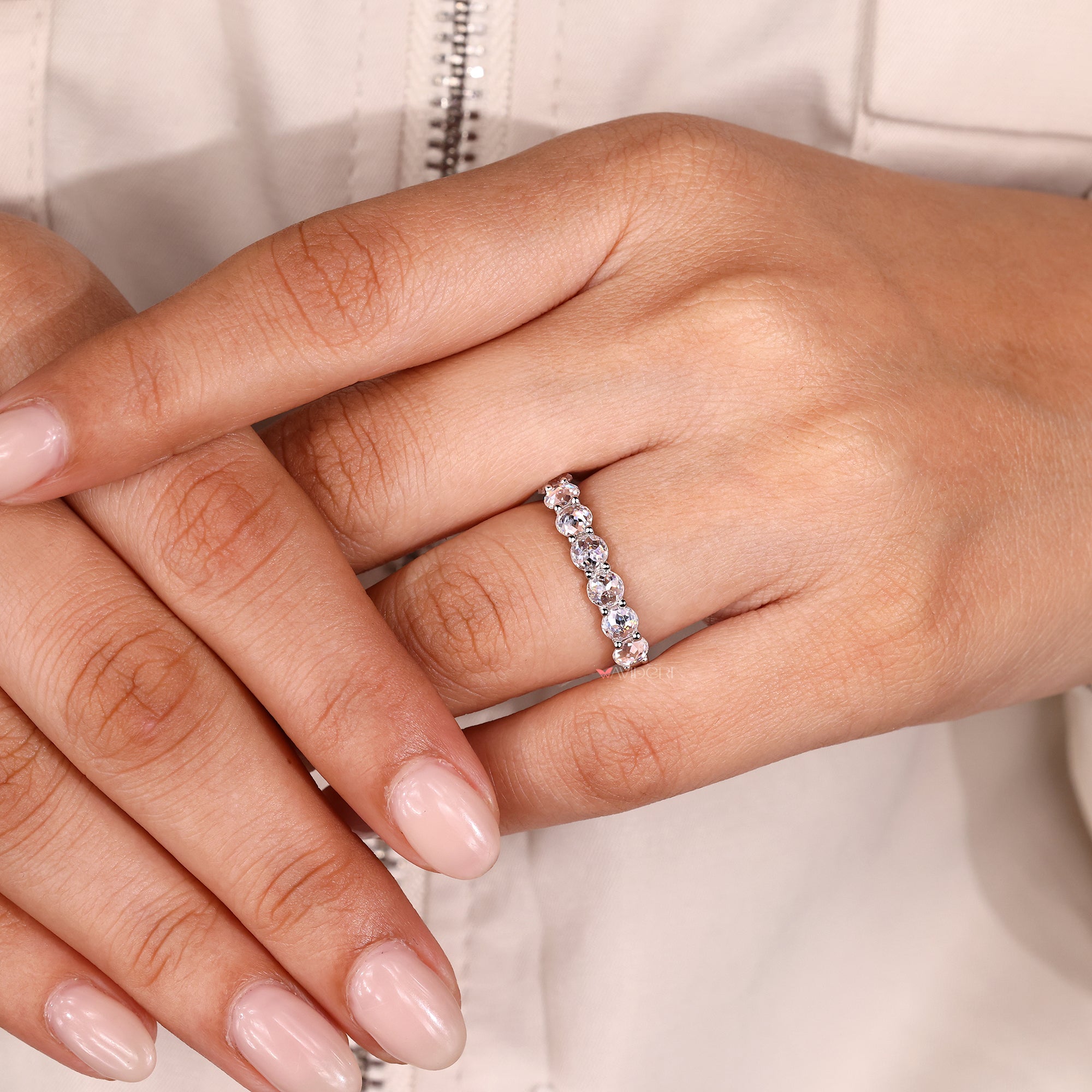 Moissanite wedding band features radiant moissanite stones set in a secure design.