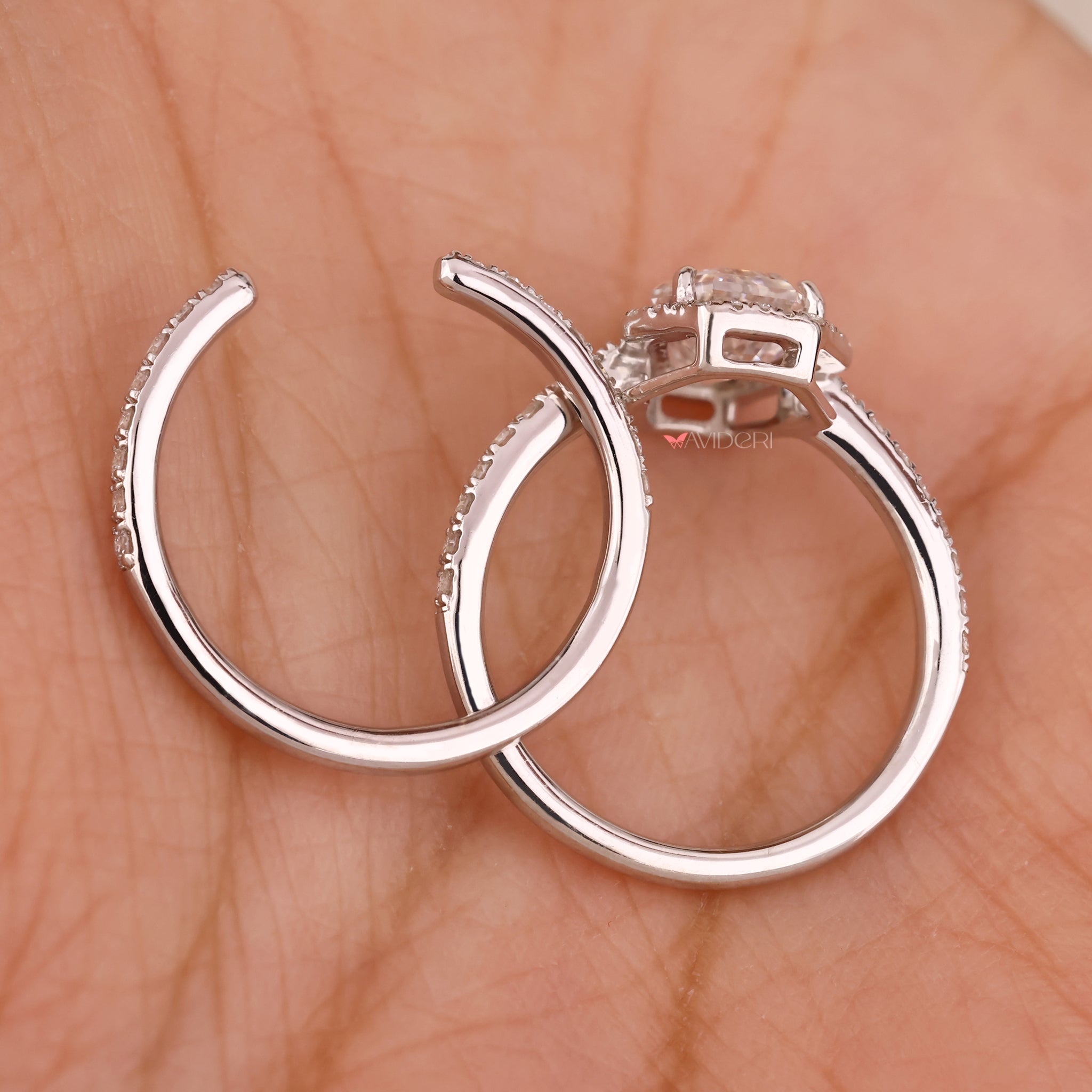 Halo diamond ring featuring a round center stone.