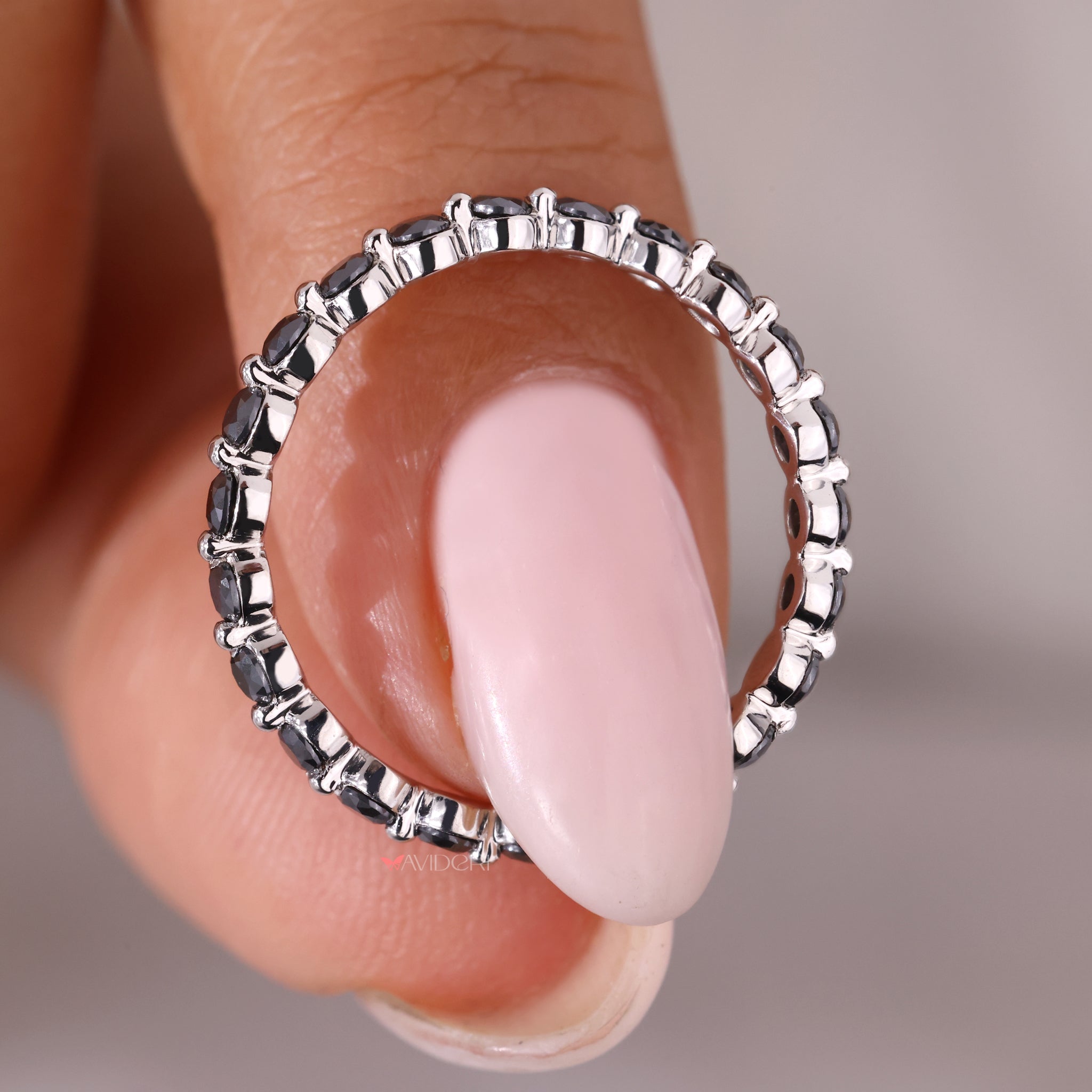 Half eternity band featuring round moissanite stones in a wedding band.