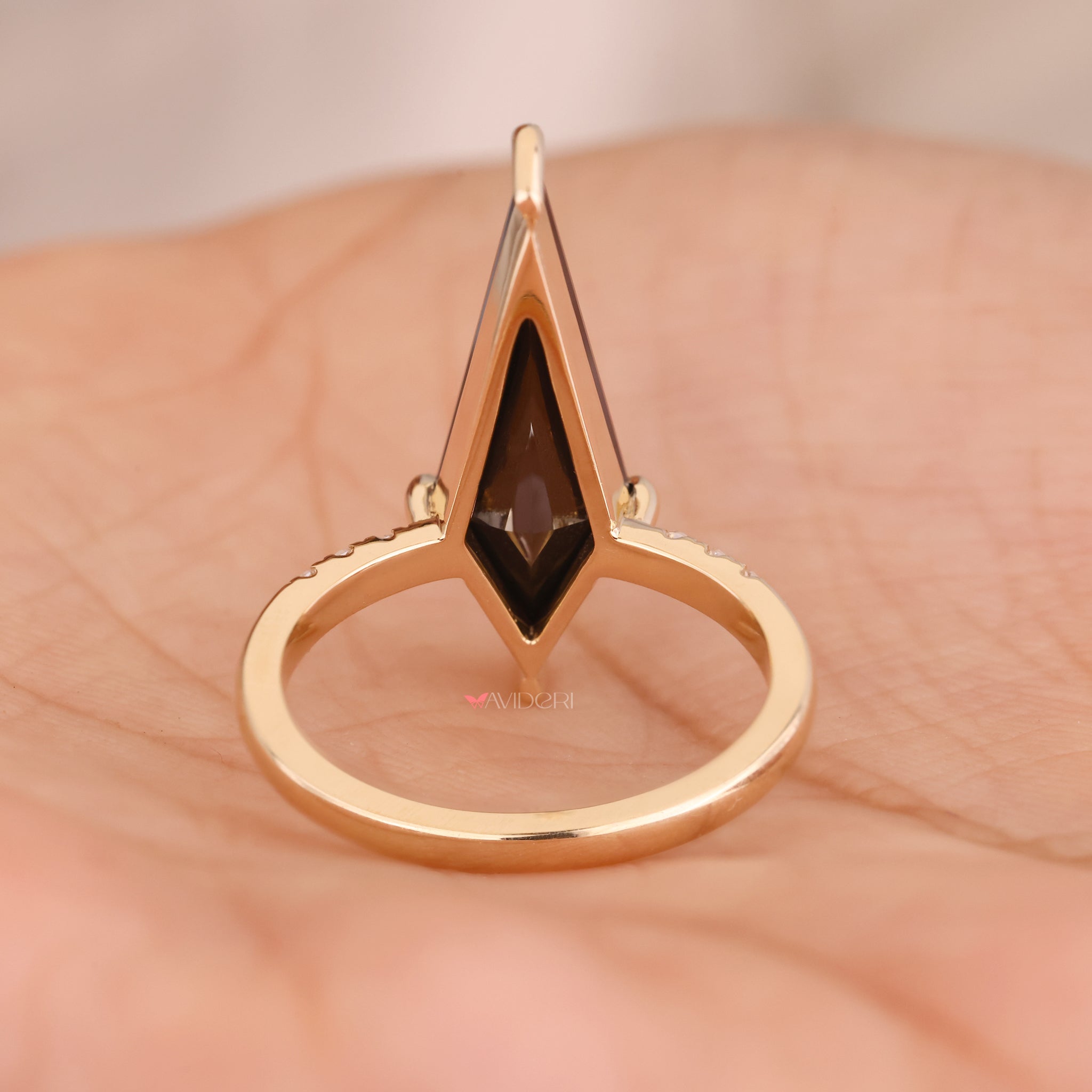 Yellow gold ring with a polished finish and bold black center stone.