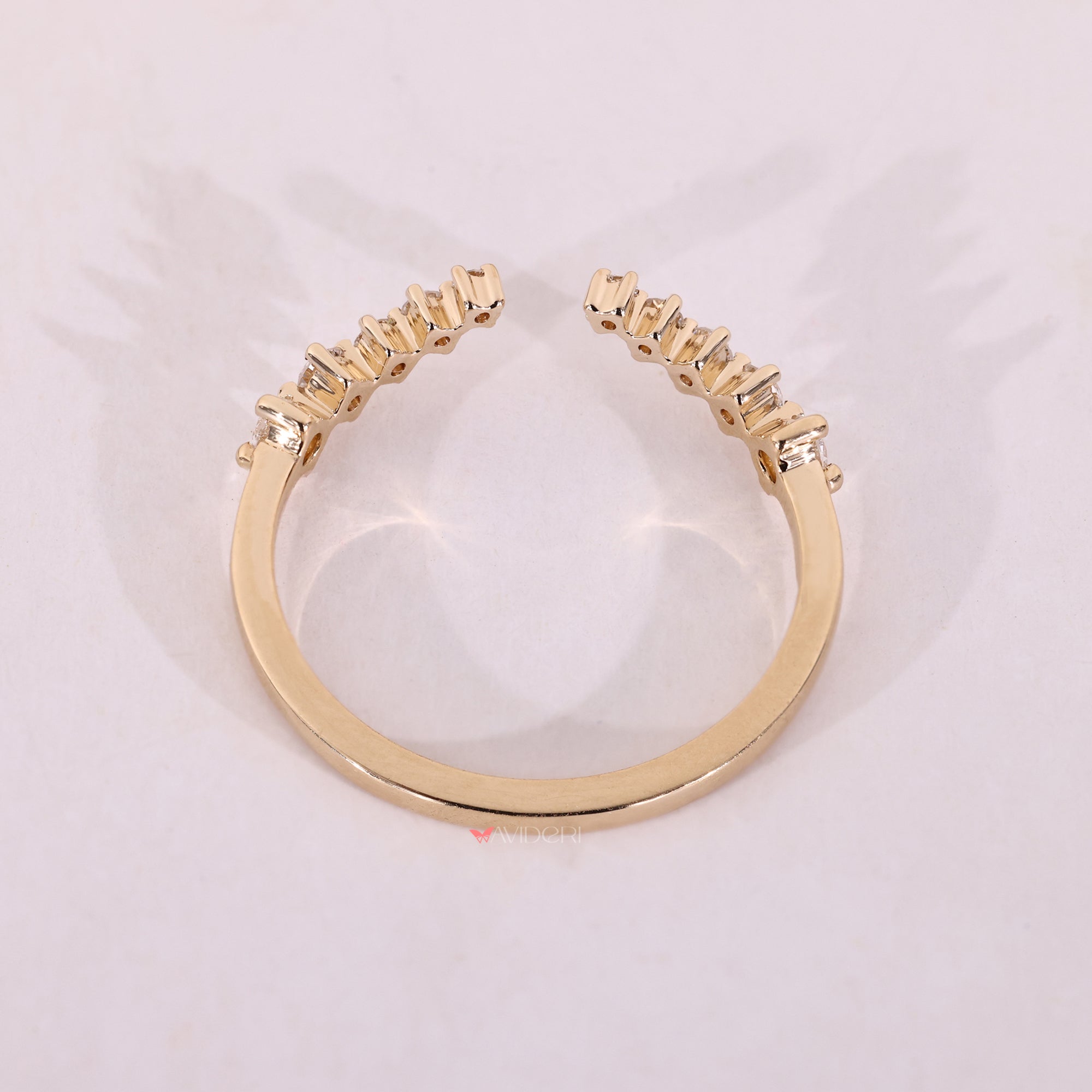 Yellow gold curved wedding band with open gap design.