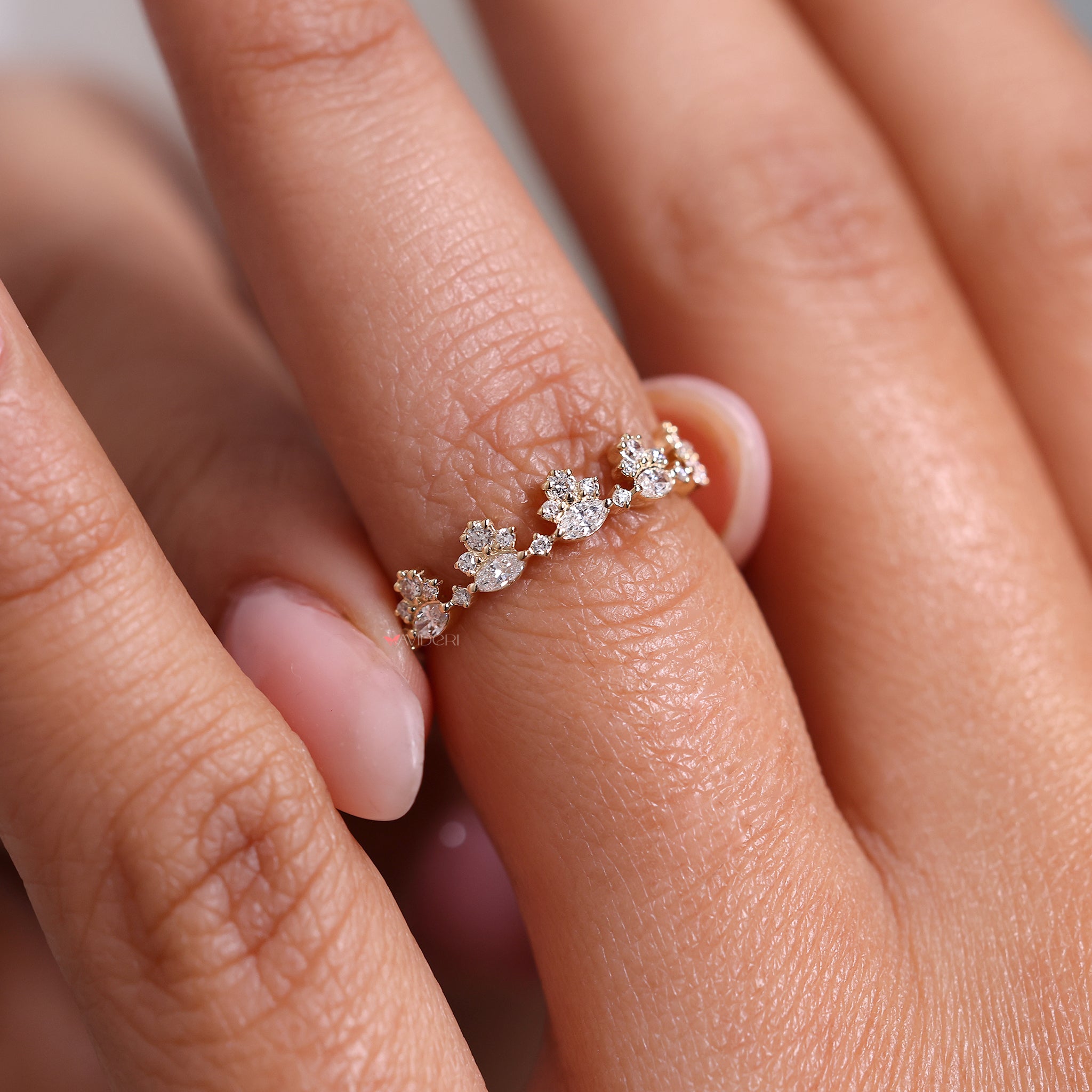 Half eternity wedding band featuring marquise and round diamonds in a shared prong style.