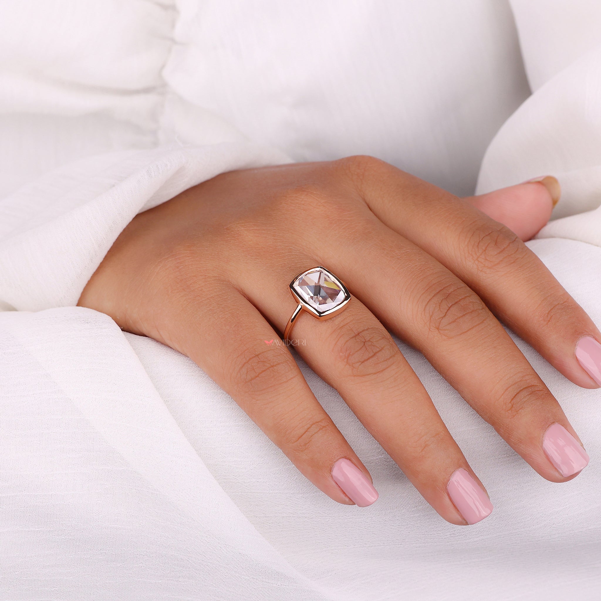 Showcase modern design through a bezel set engagement ring featuring a secure and sleek setting.
