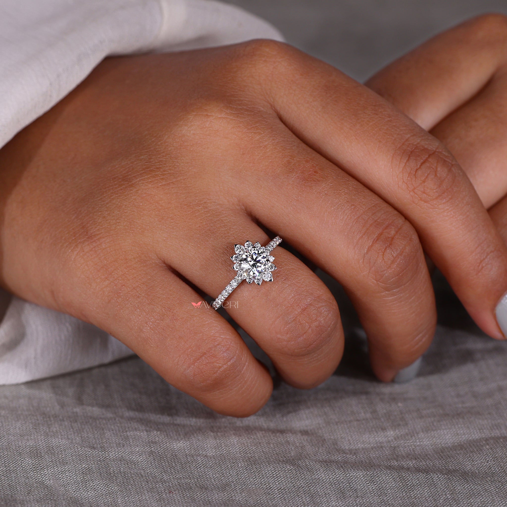 Halo ring ring featuring a pave engagement ring design with igi certified round cut diamond accents for a glamorous look.
