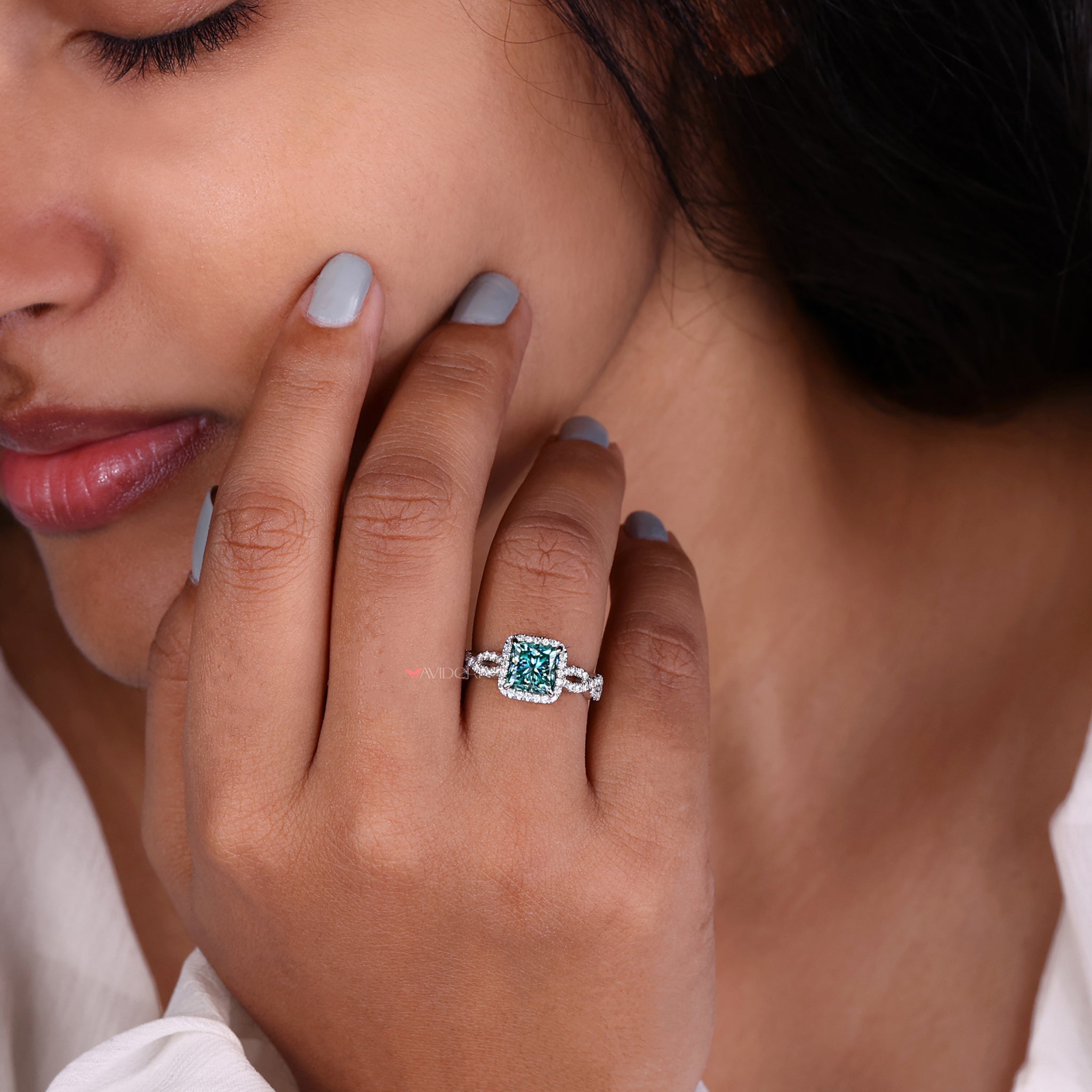 Cyan blue moissanite ring for a striking and vibrant appearance.
