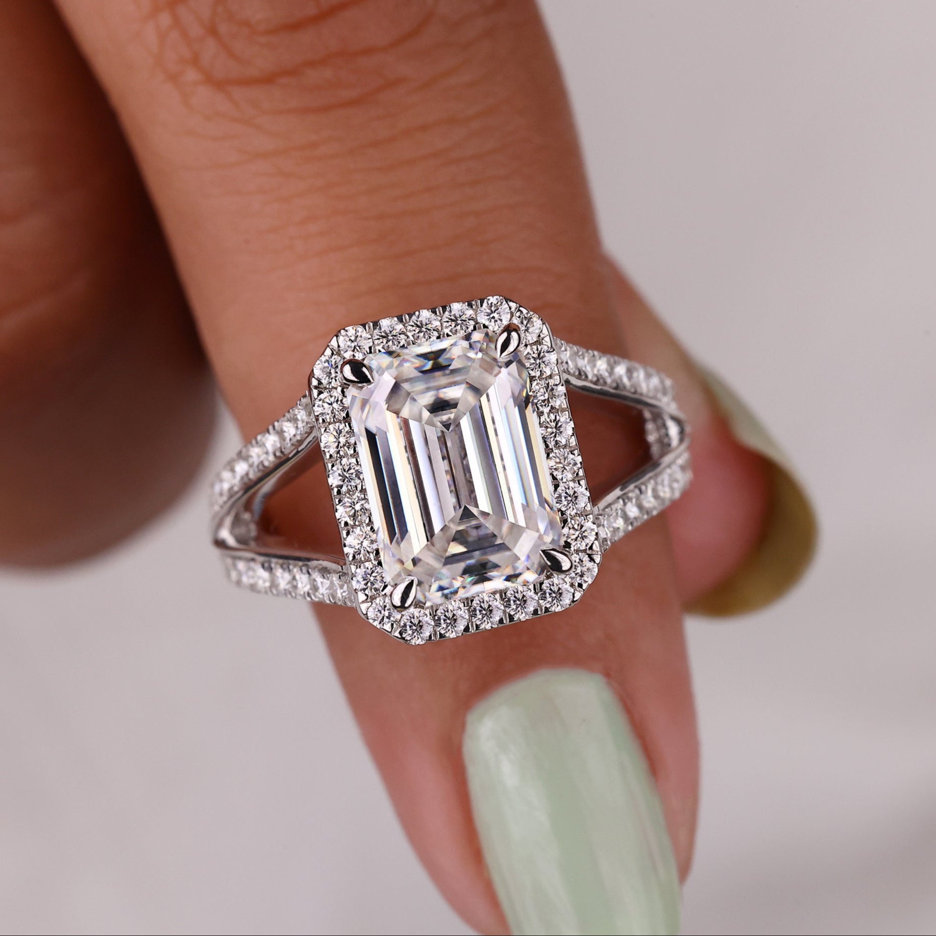 Emerald Moissanite engagement ring featuring a vibrant green stone and elegant design.
