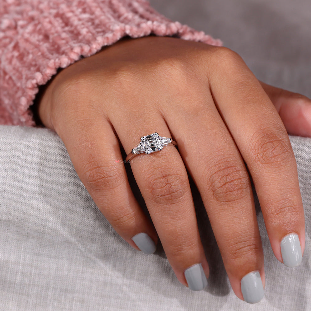 Asscher cut diamond ring in a tapered baguette engagement ring style for an elegant and modern appearance.

