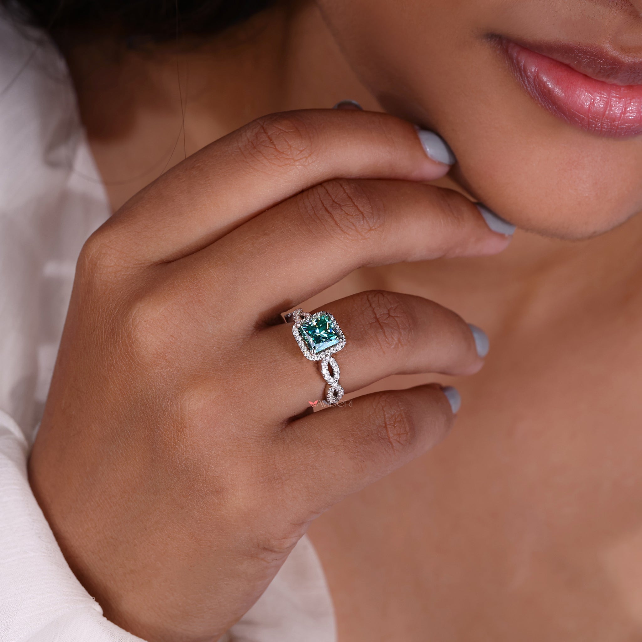 Princess cut halo engagement ring with a secure and classic setting.
