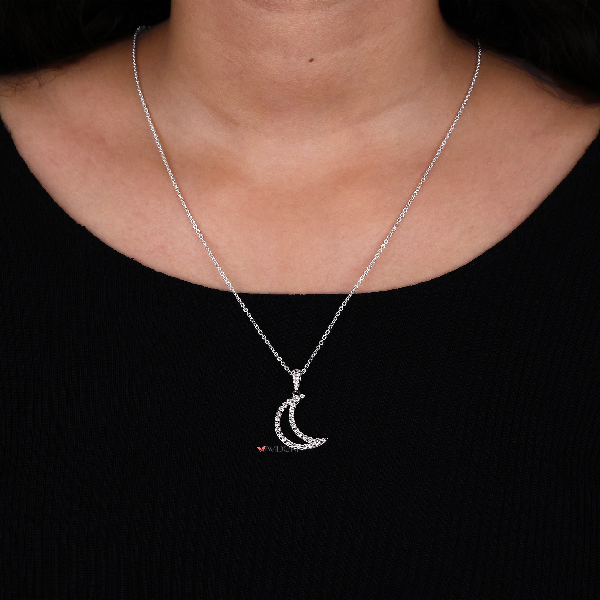 Round cut half moon pendant captures light with its striking shape.