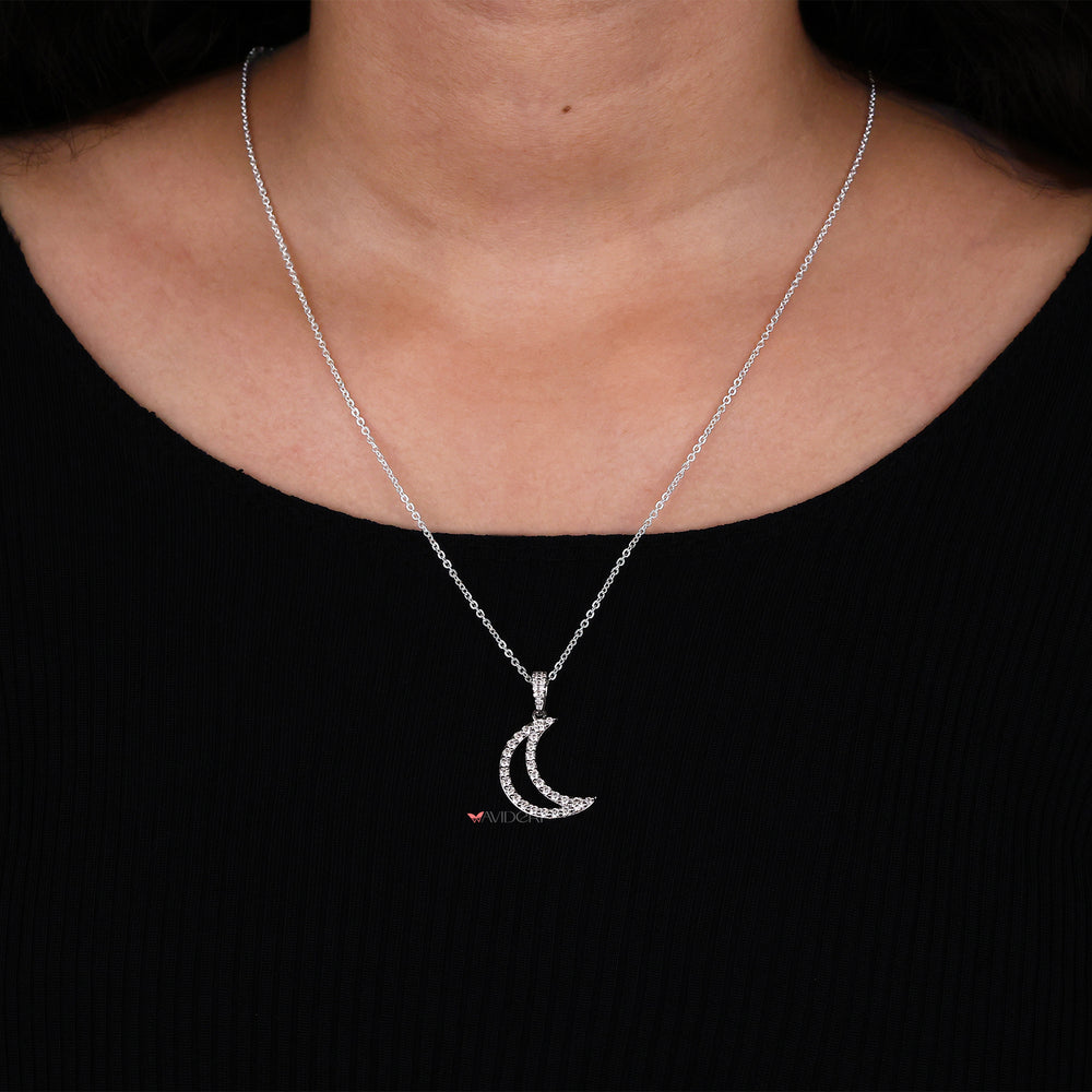 Round cut half moon pendant captures light with its striking shape.