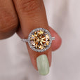 Round engagement ring with a white gold band.
