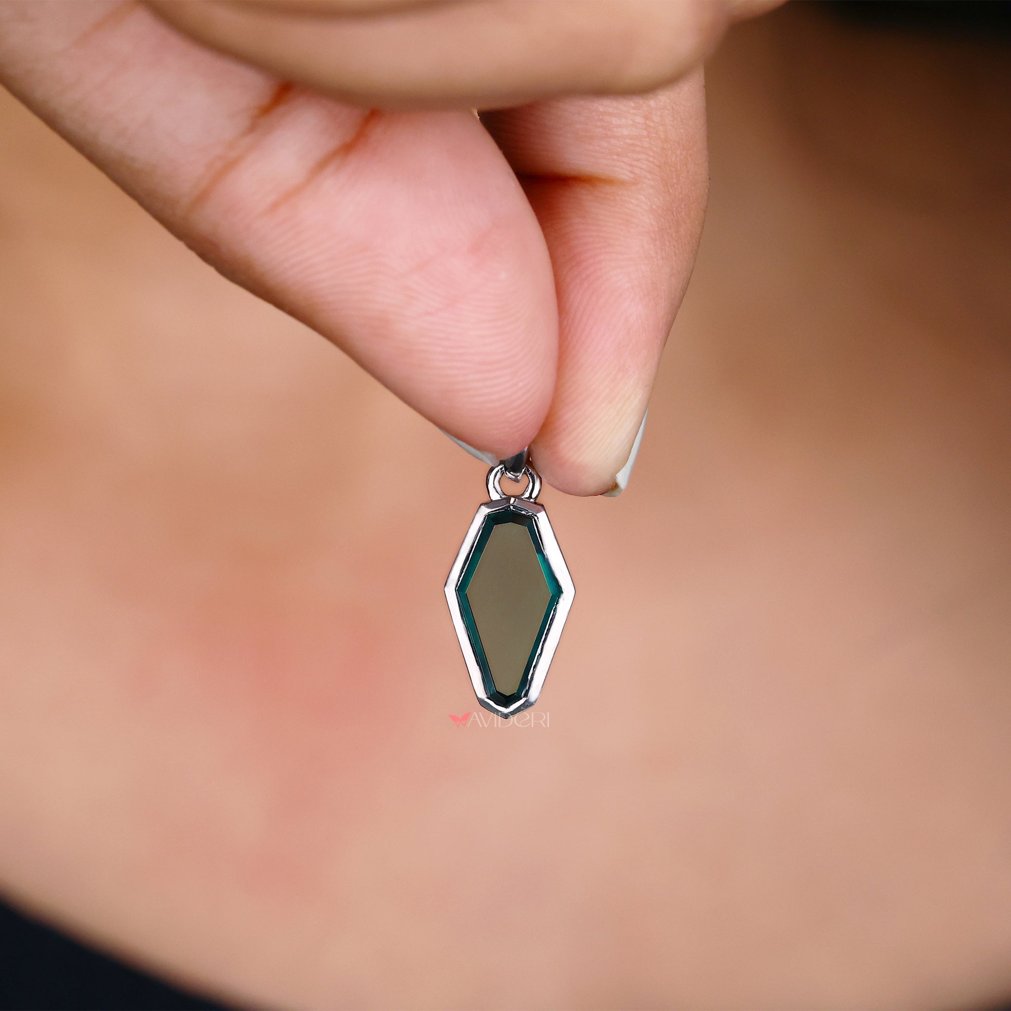 Green Portrait Cut Coffin moissanite pendant shines with eco-friendly beauty and bold design.