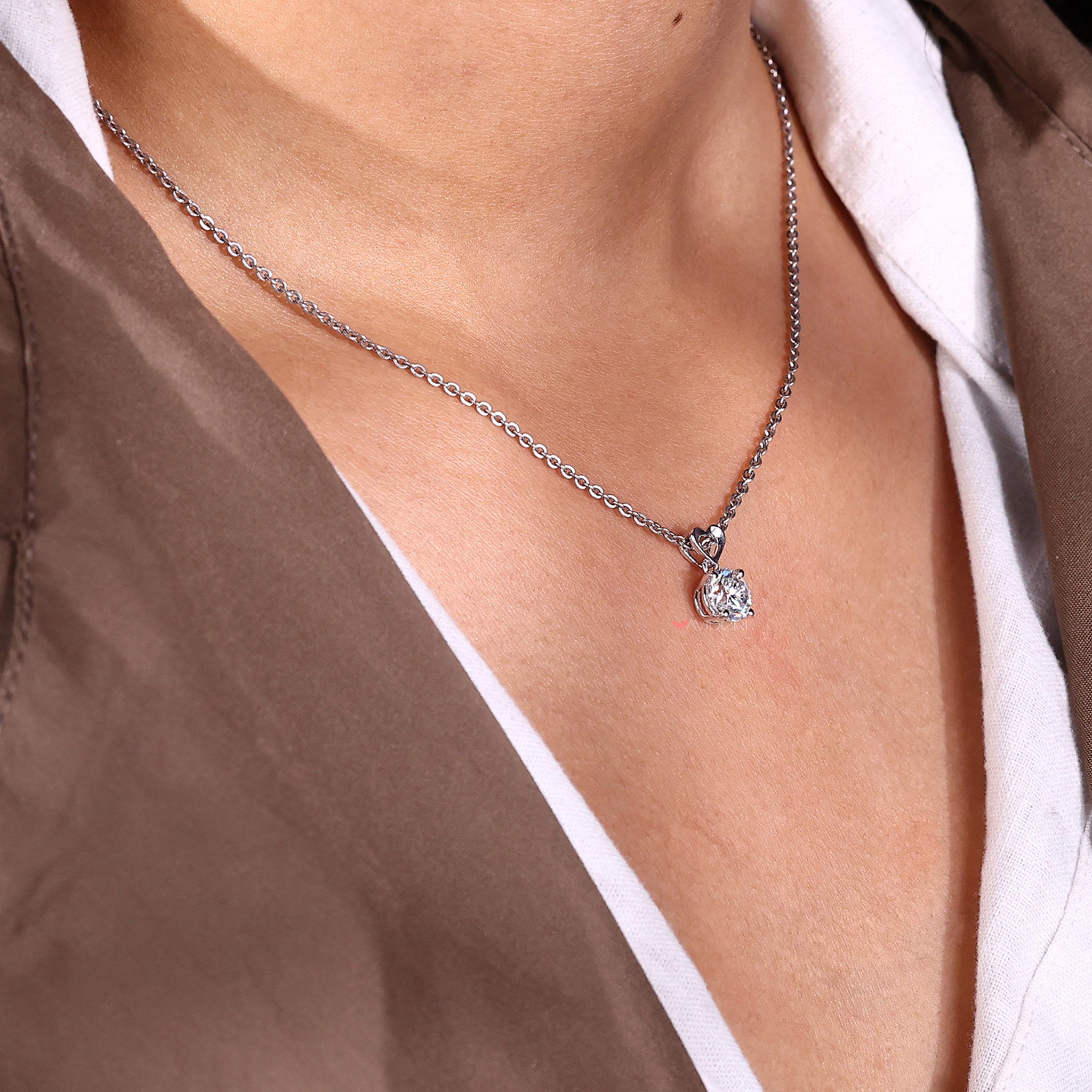 Round cut moissanite pendant set in a fine white gold chain, perfect for all occasions.