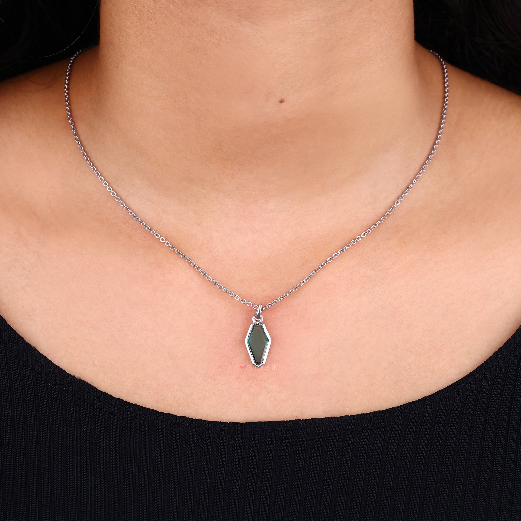 Green Portrait Cut Coffin pendant adds a unique touch with vibrant color.