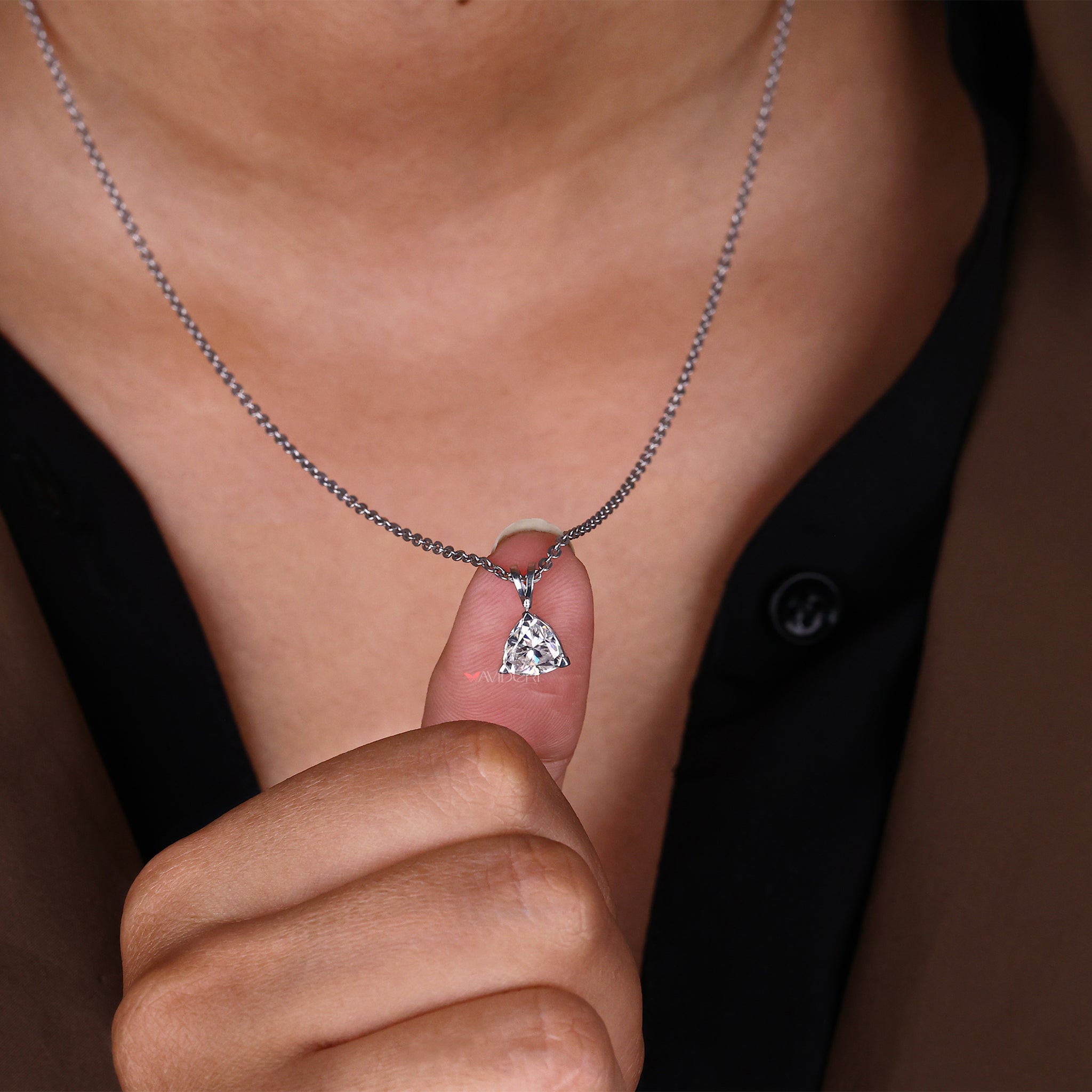 White gold trillion pendant settings, designed to highlight the beauty of the trillion-cut stone.