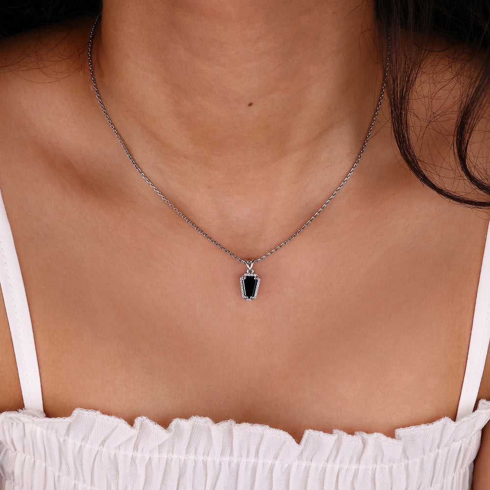 Custom moissanite pendant set in a coffin pendant for a personalized touch.