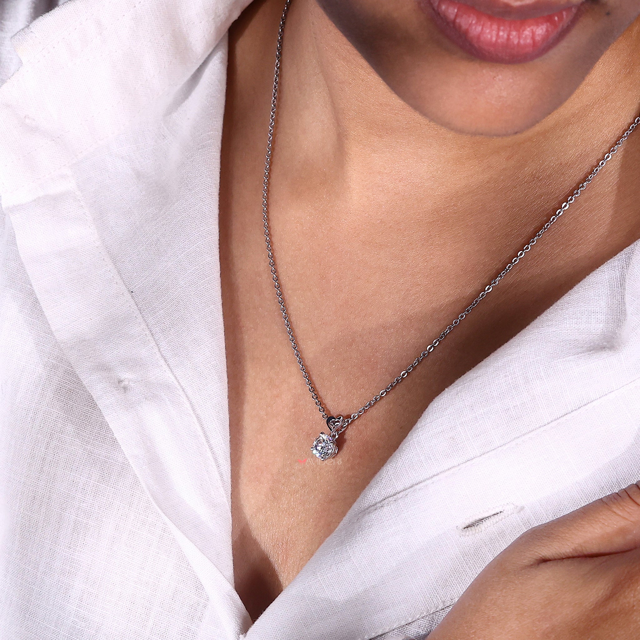 Round cut solitaire pendant with a brilliant moissanite stone for a sparkling touch.