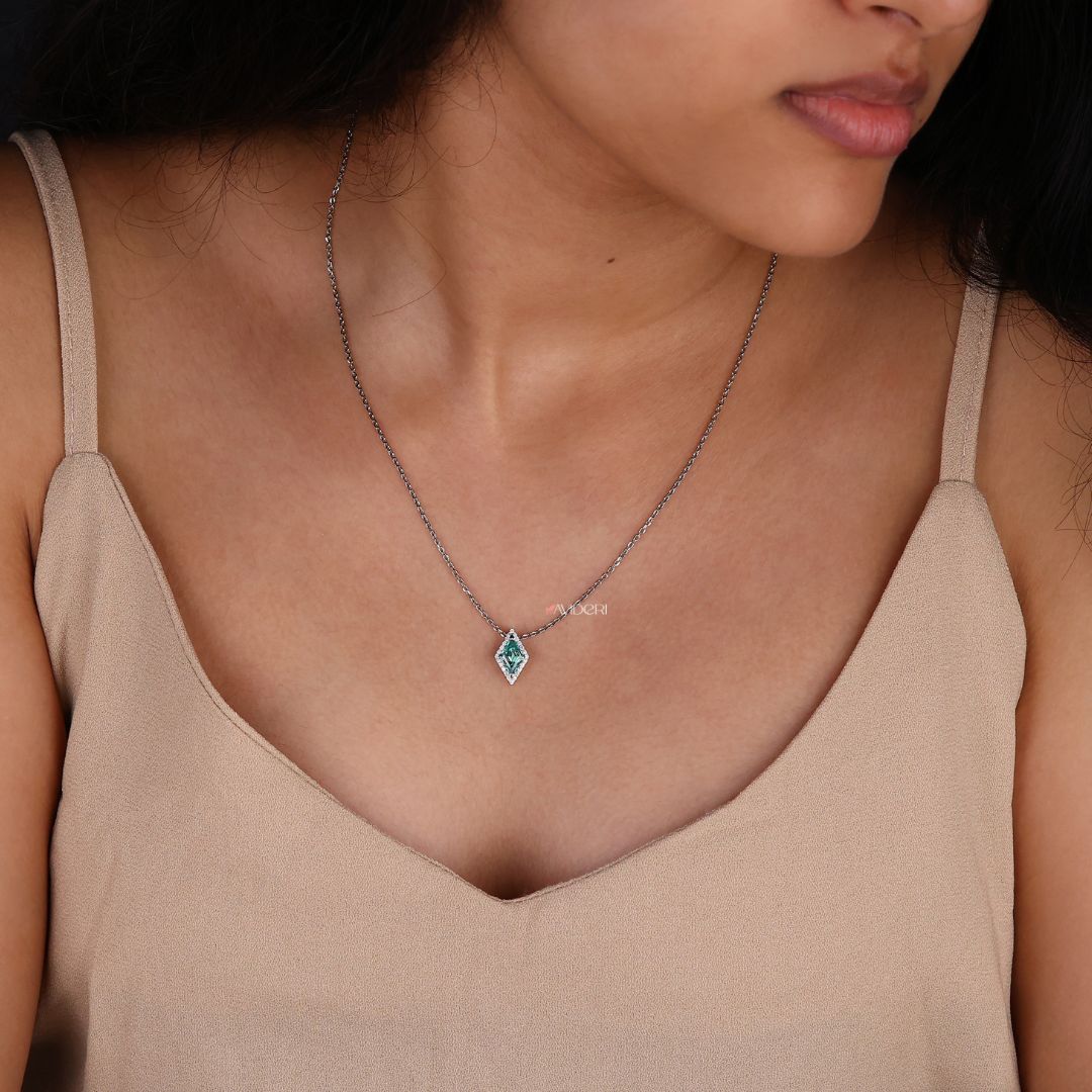 Handmade jewelry featuring a lozenge cut moissanite pendant.
