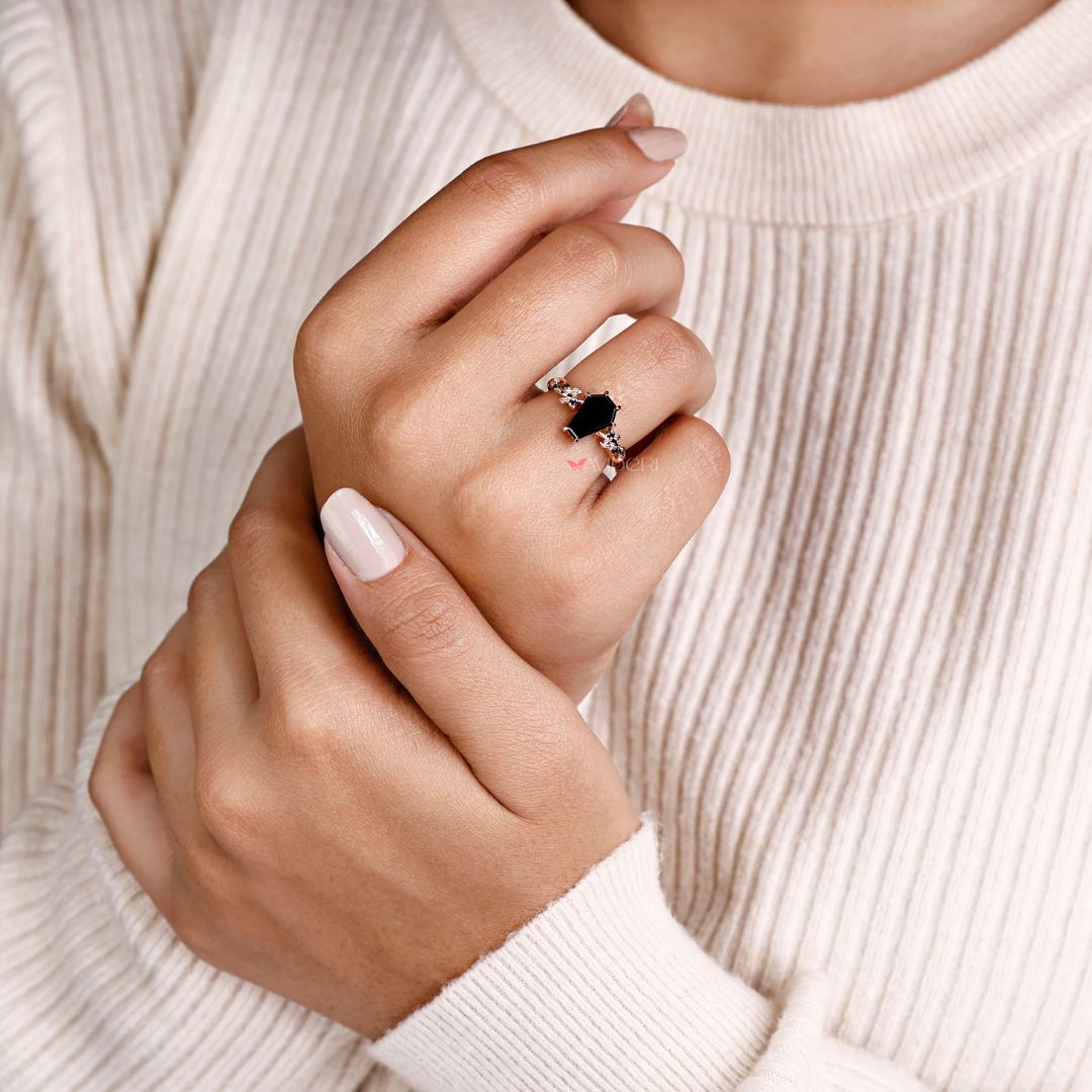 Handmade ring with intricate craftsmanship and a coffin ring setting.
