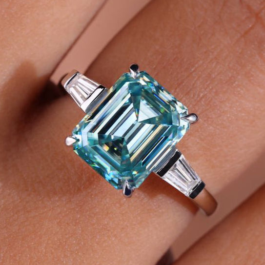 3 stone moissanite ring featuring brilliant stones.
