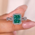 Radiant cut engagement ring with a dazzling cyan blue moissanite stone.
