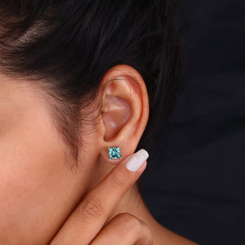Earrings featuring cyan blue Princess Cut Moissanite in white gold.