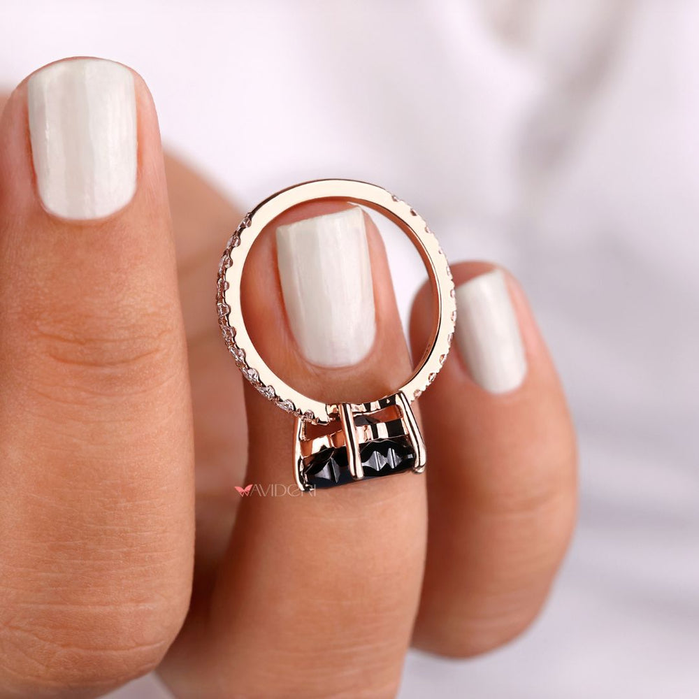 Rose gold engagement ring with black butterfly accents for a modern style.

