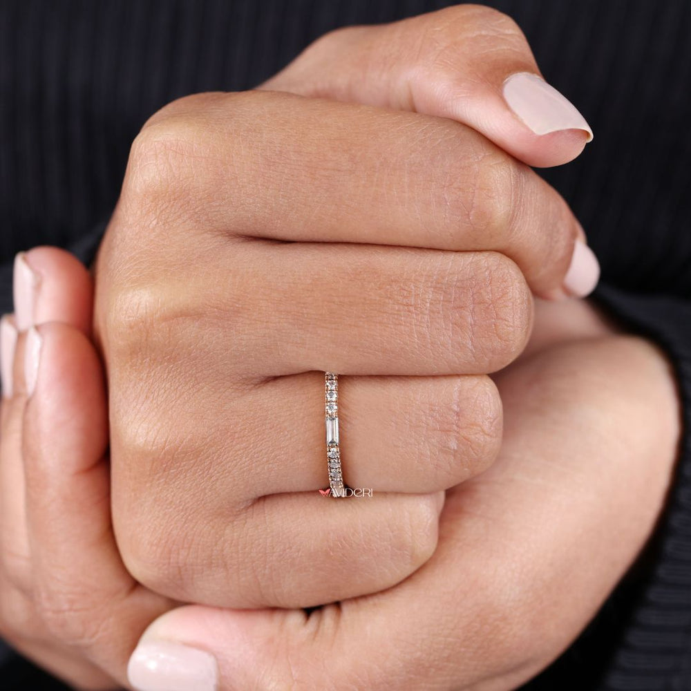 Stackable wedding ring adds layering versatility with minimalist charm.
