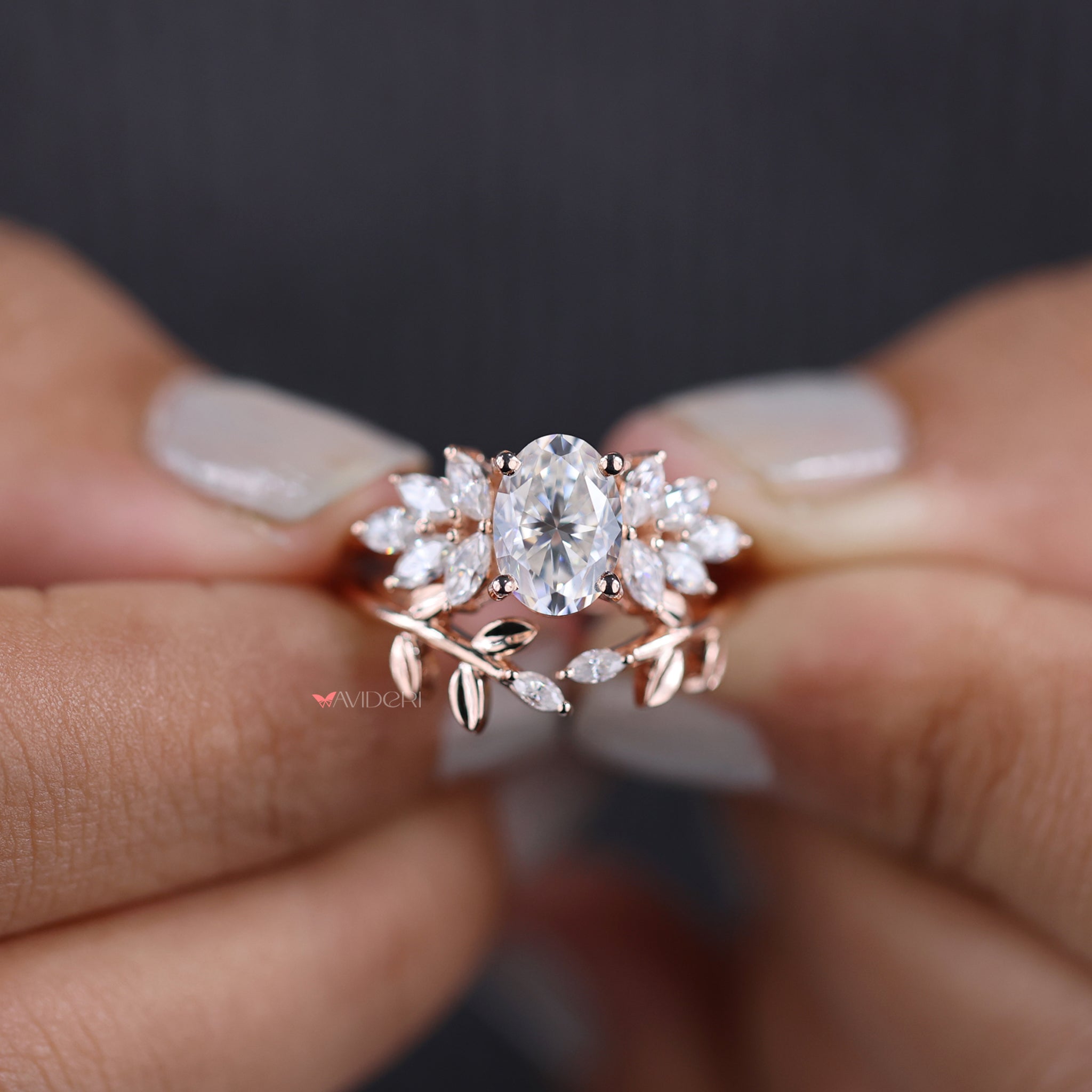 Muse ring featuring oval and marquise cut stones in a leaf style setting.
