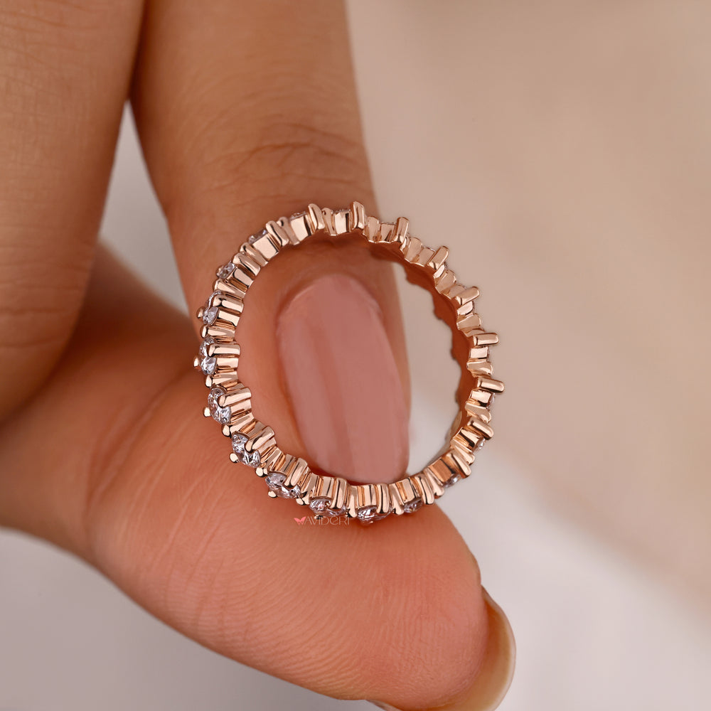 Rose gold diamond eternity band featuring sparkling stones.
