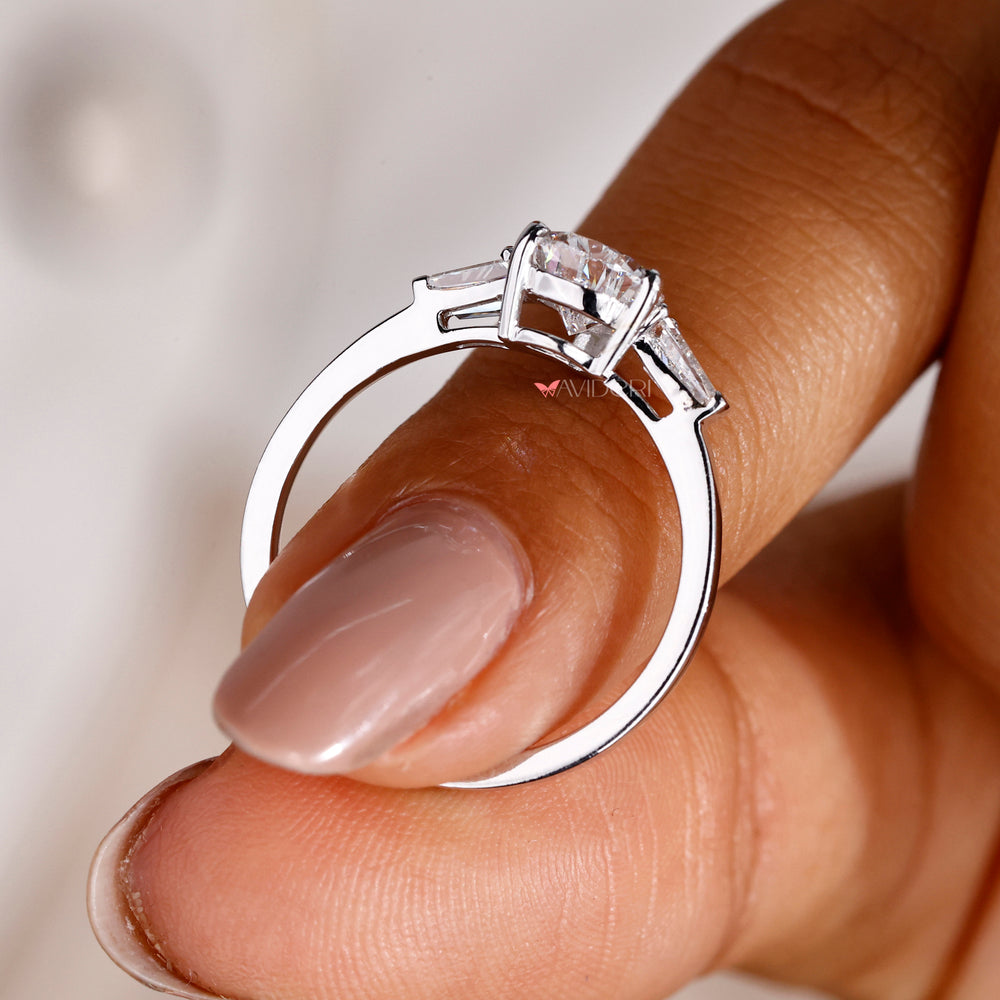 Pear diamond engagement ring with 2 Tapered Baguette side stones for a modern and elegant look.

