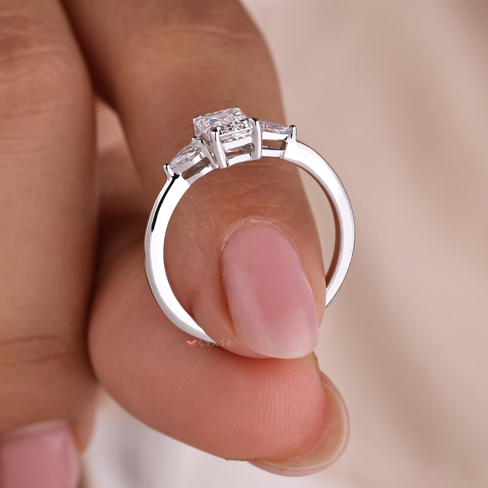Emerald cut ring crafted with three diamond engagement ring design, ideal for classic and modern style preferences.
