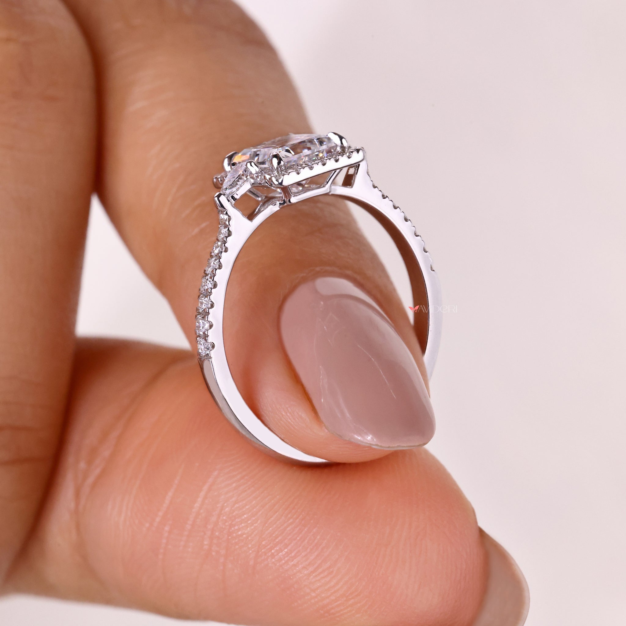 Princess cut halo ring designed with pavé diamonds to enhance the brilliance of the centerpiece.
